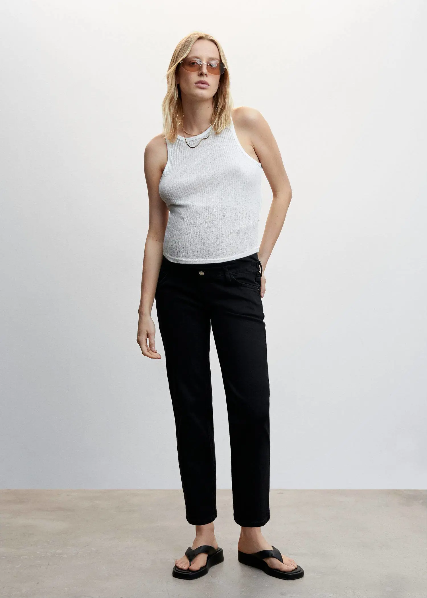 Mango Maternity Straight Jeans. a woman standing in front of a white wall. 