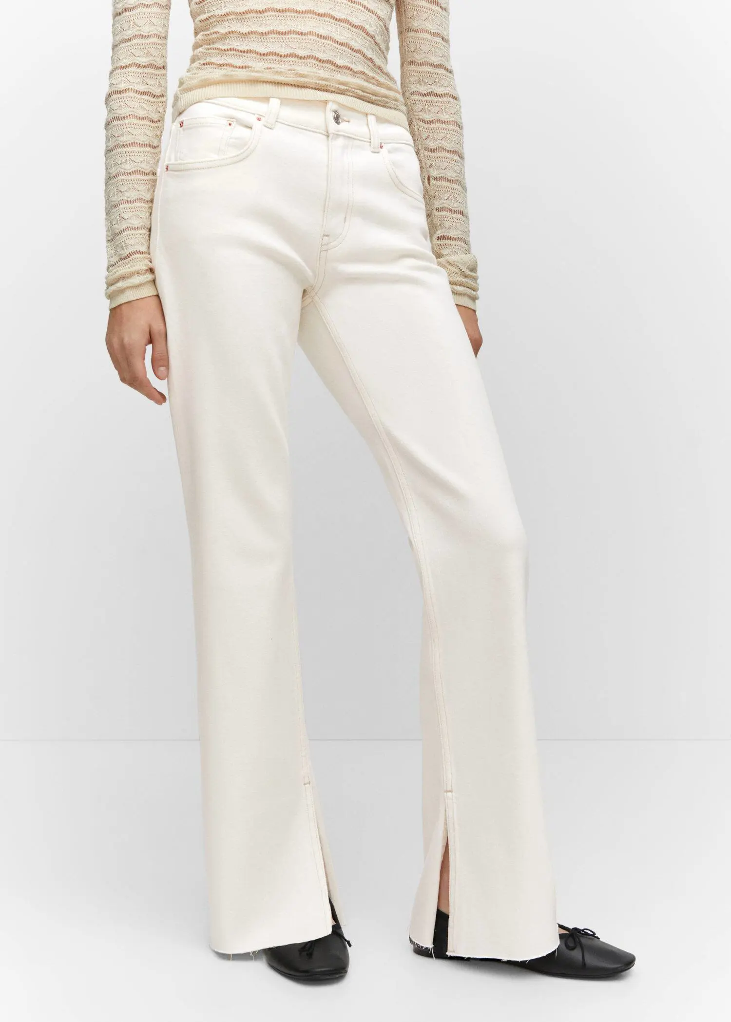 Mango Medium-rise straight jeans with slits. a woman in white pants and a long sleeve shirt. 