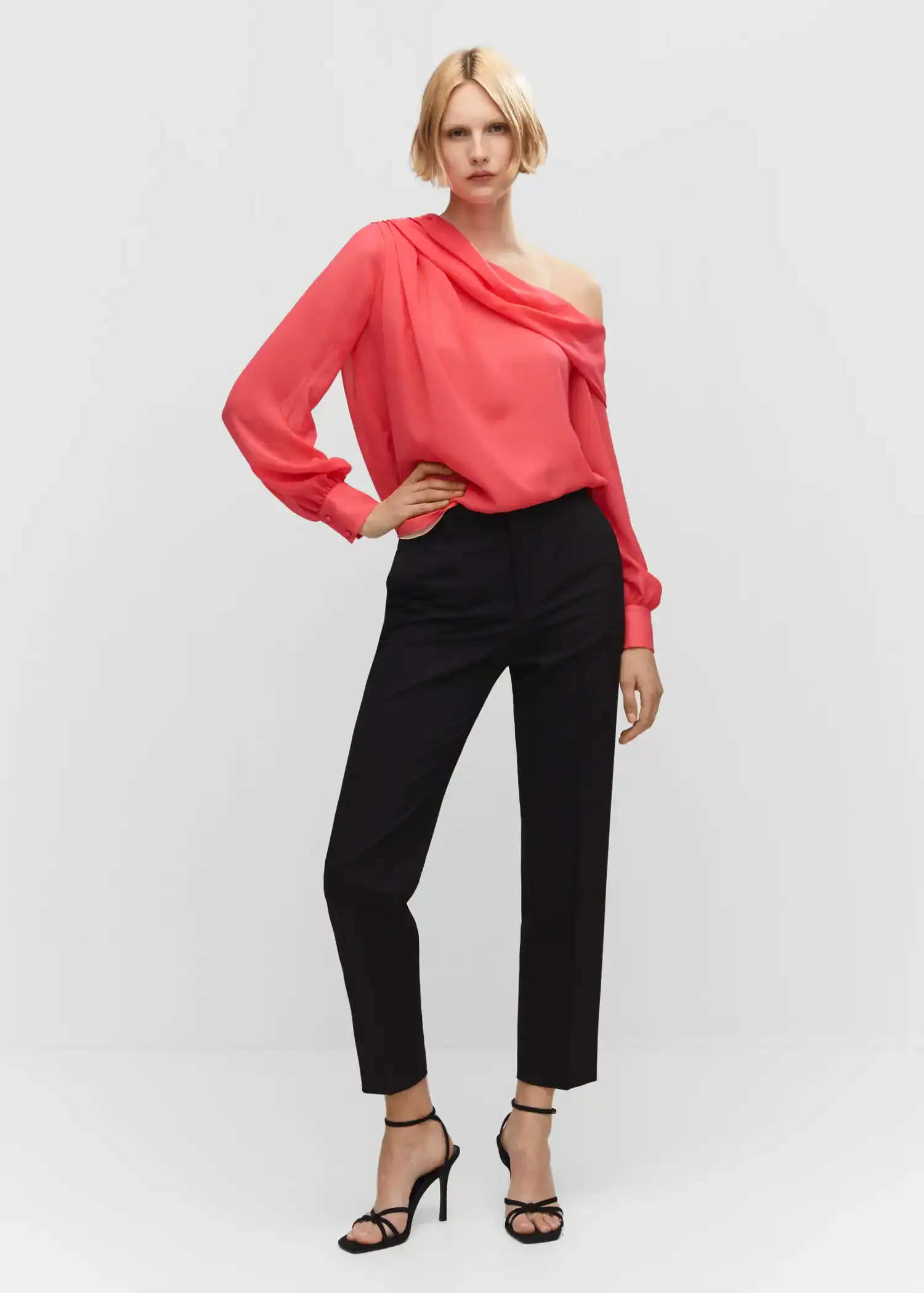 Mango Asymmetrical oversized blouse. a woman wearing a red top and black pants. 