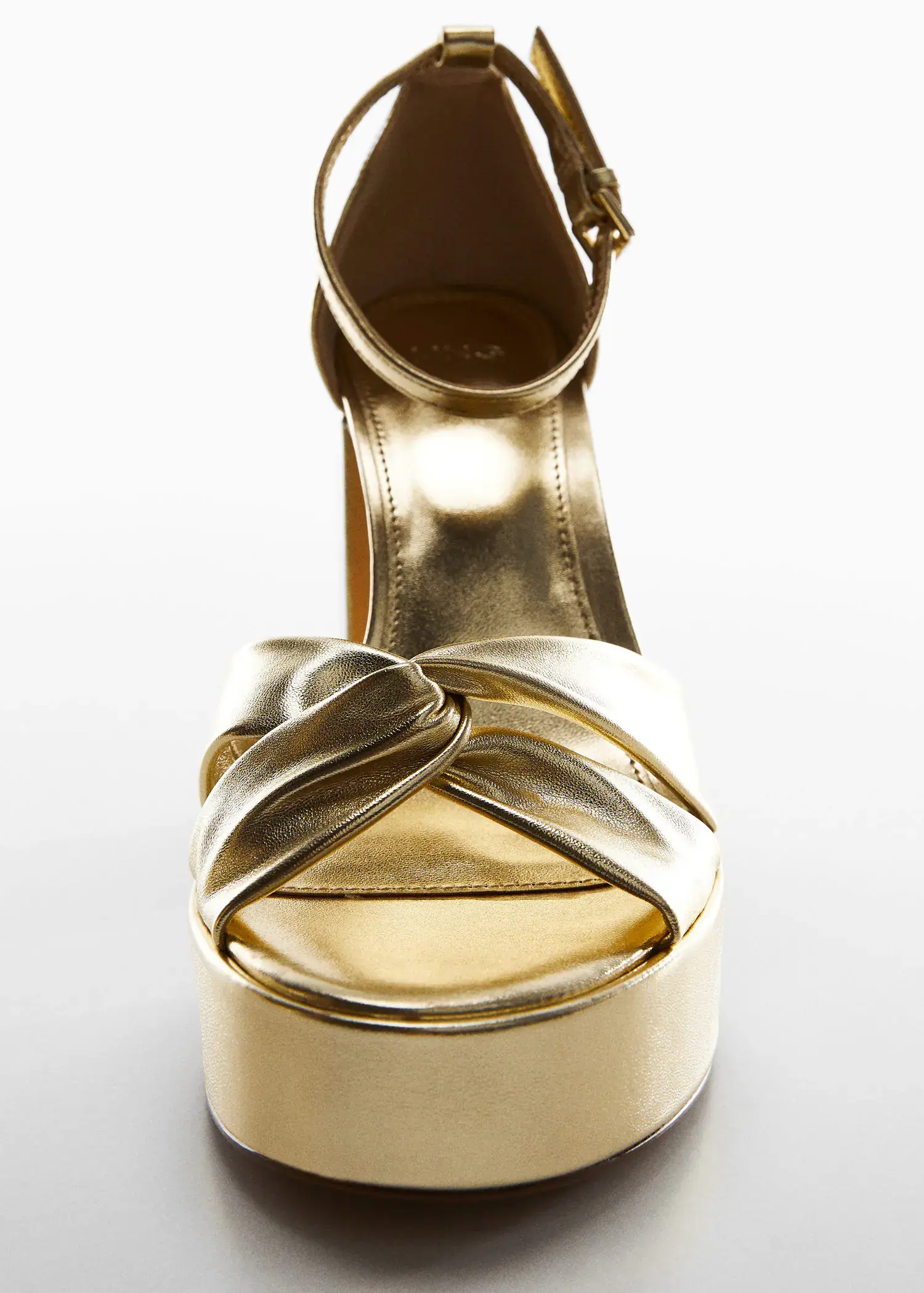 Mango Metallic heel sandals. a close up of a pair of gold shoes 