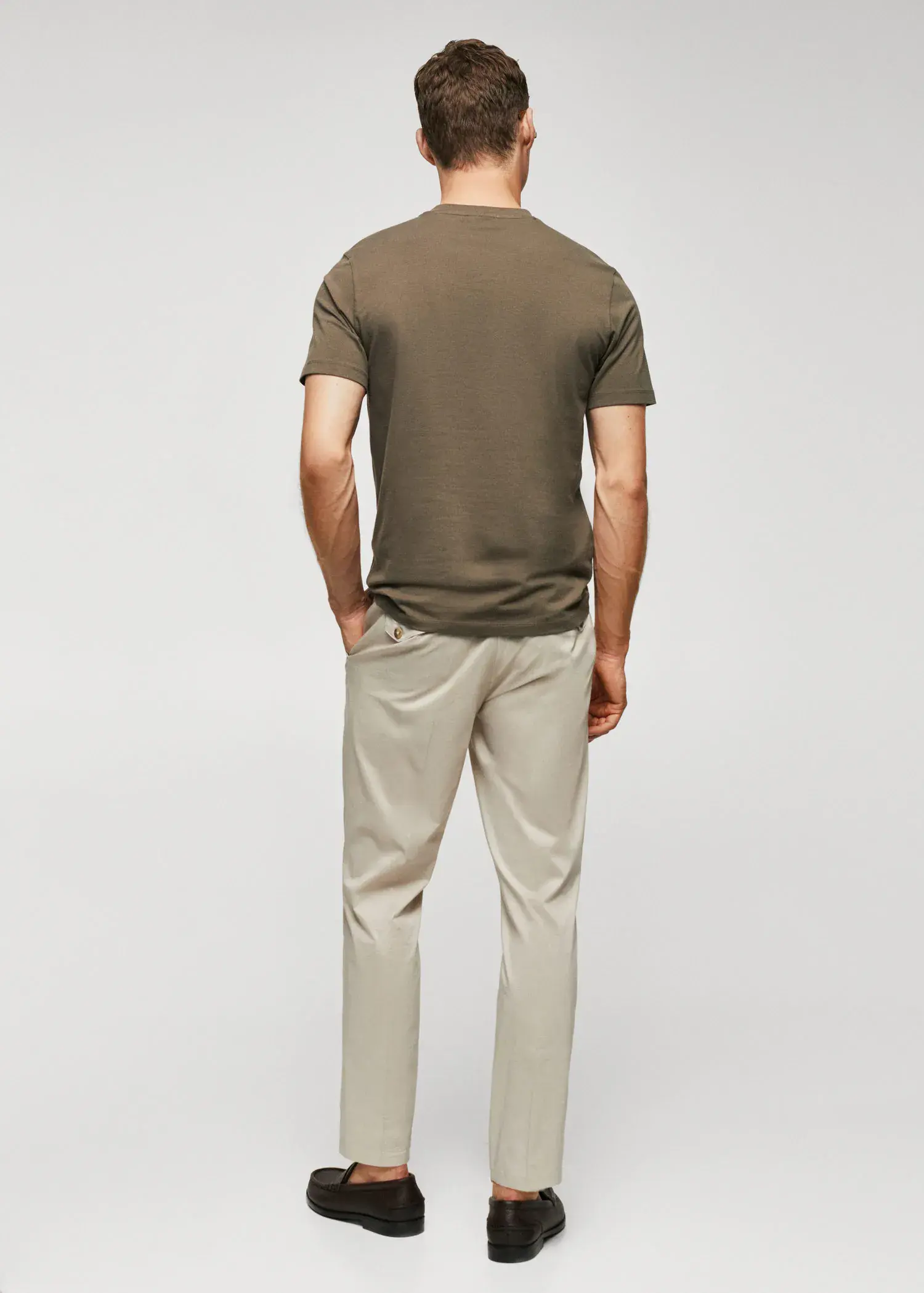 Mango Stretch cotton T-shirt. a man standing with his hands in his pockets. 