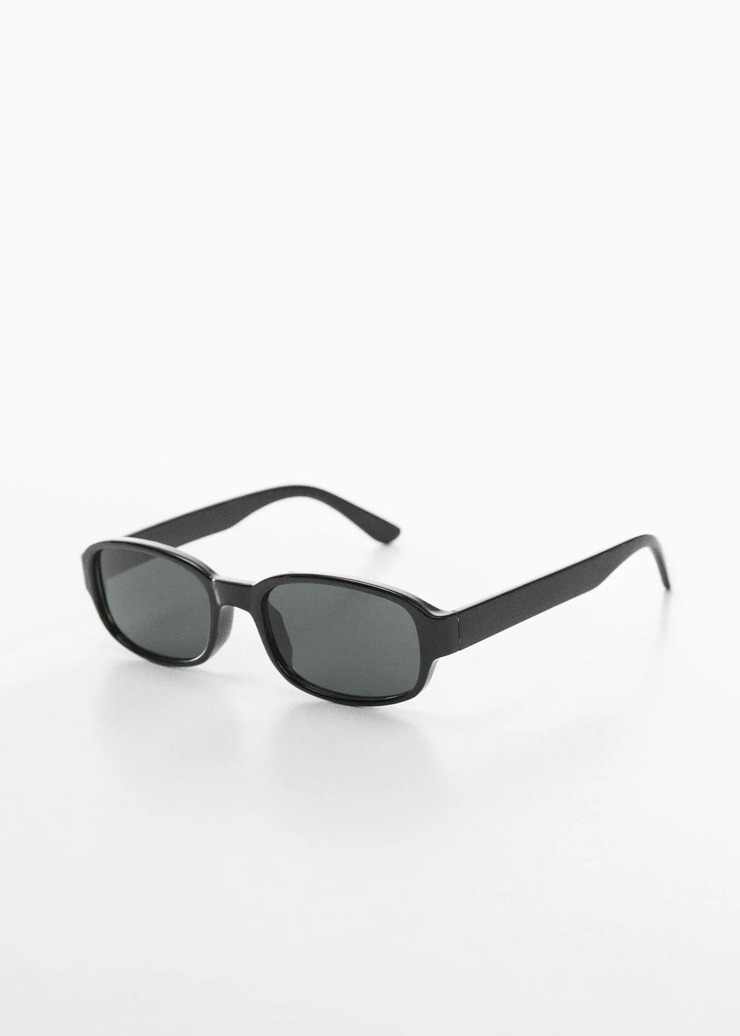 Mango Retro style sunglasses. a pair of black sunglasses on a white surface 