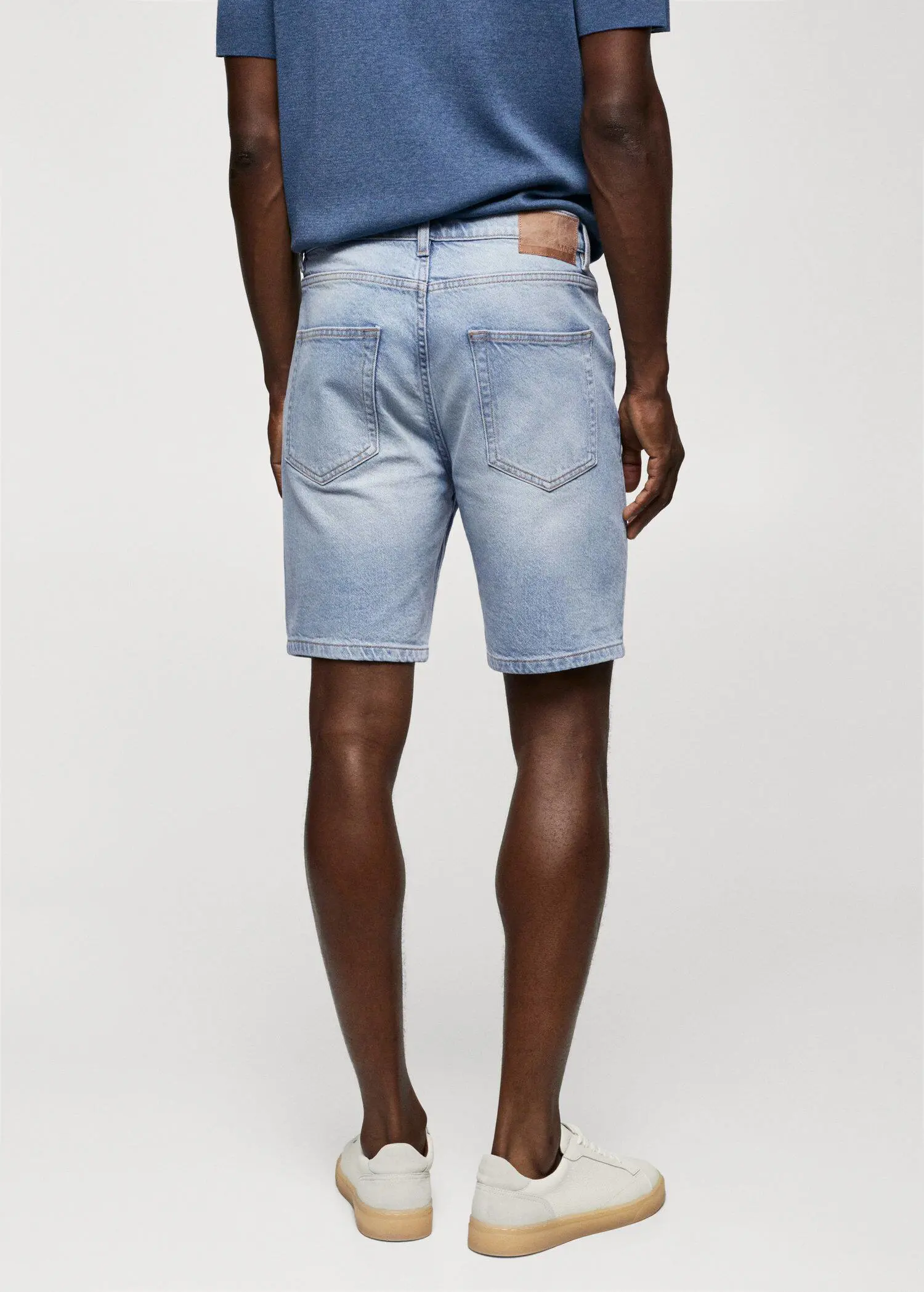 Mango Regular-fit denim bermuda shorts. a man wearing a pair of light blue shorts. 