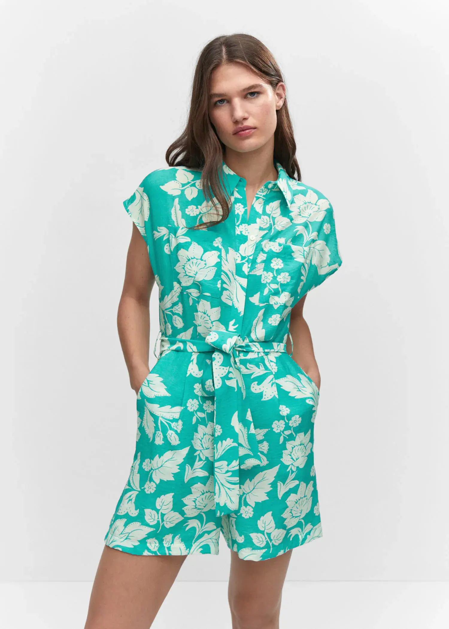Mango Floral-print jumpsuit with tie. a woman wearing a green and white floral dress. 