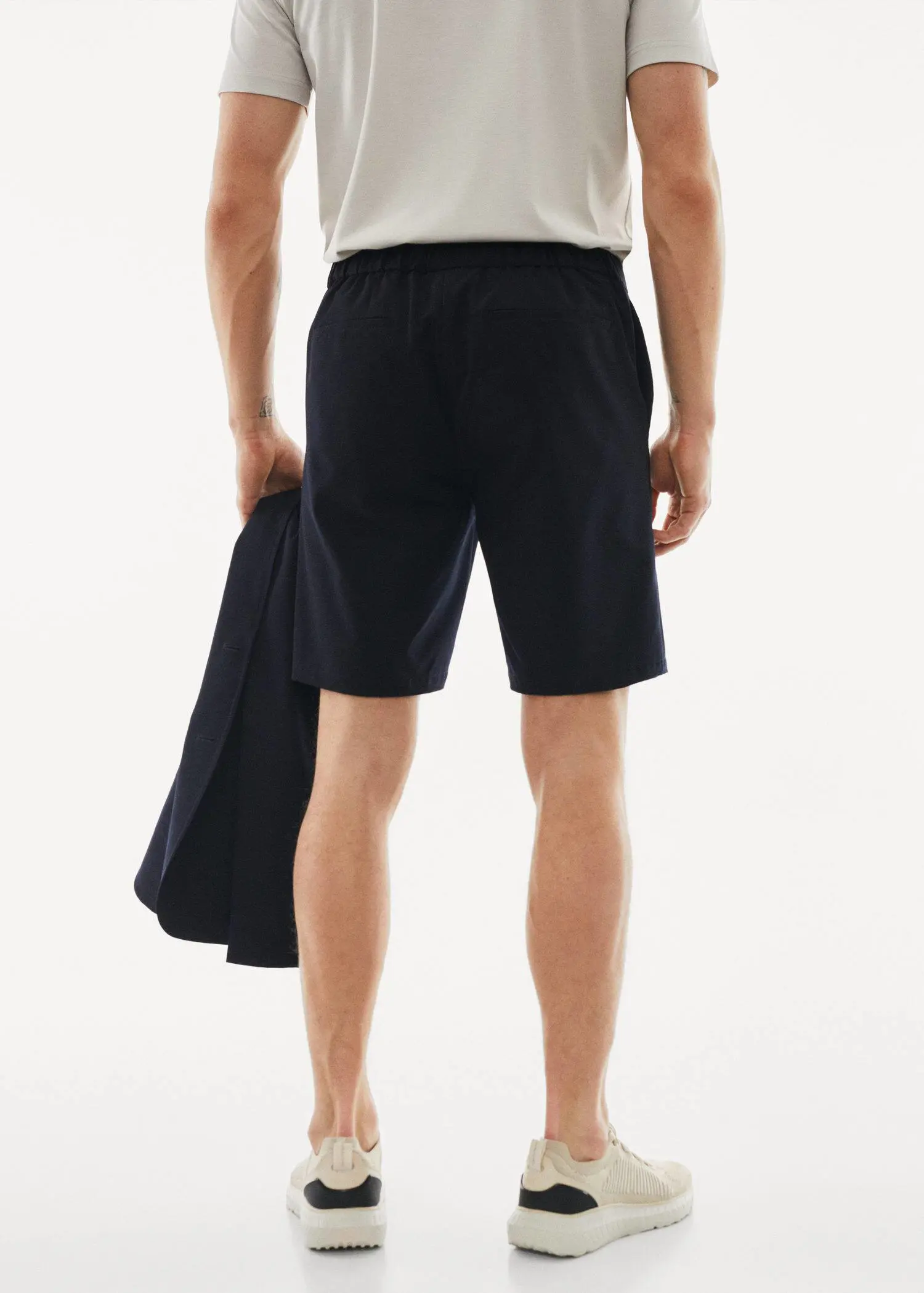 Mango Water-repellent stretch shorts. a man in black shorts and a white t-shirt 
