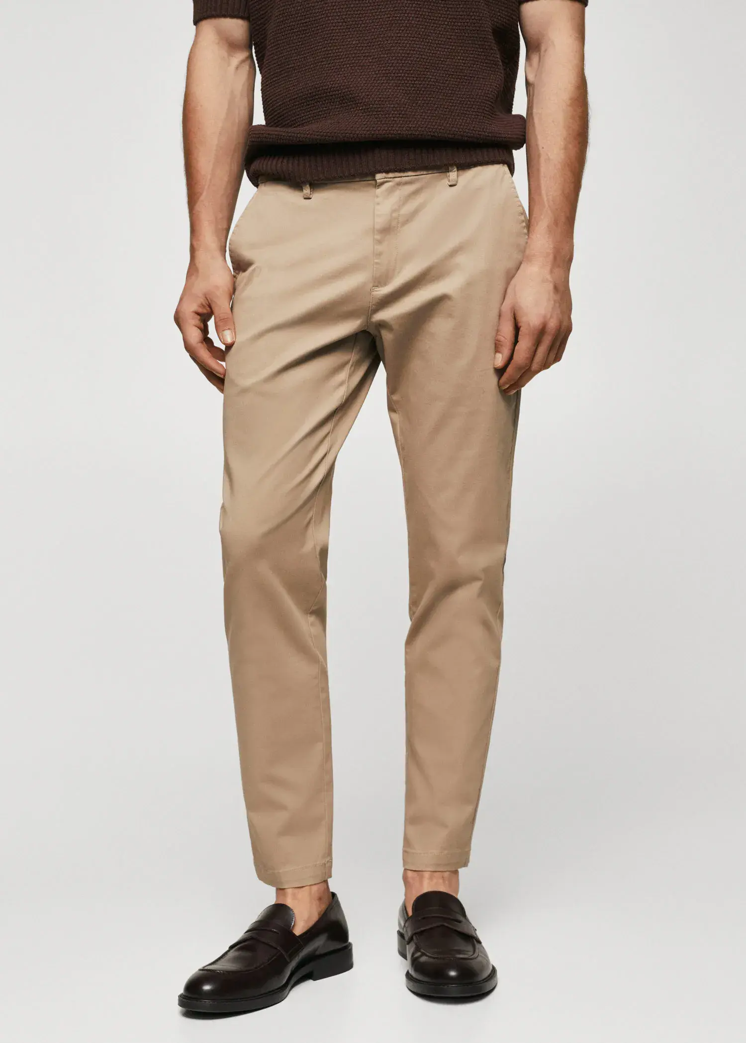 Mango Cotton tapered crop pants. a man wearing a tan pair of chinos. 