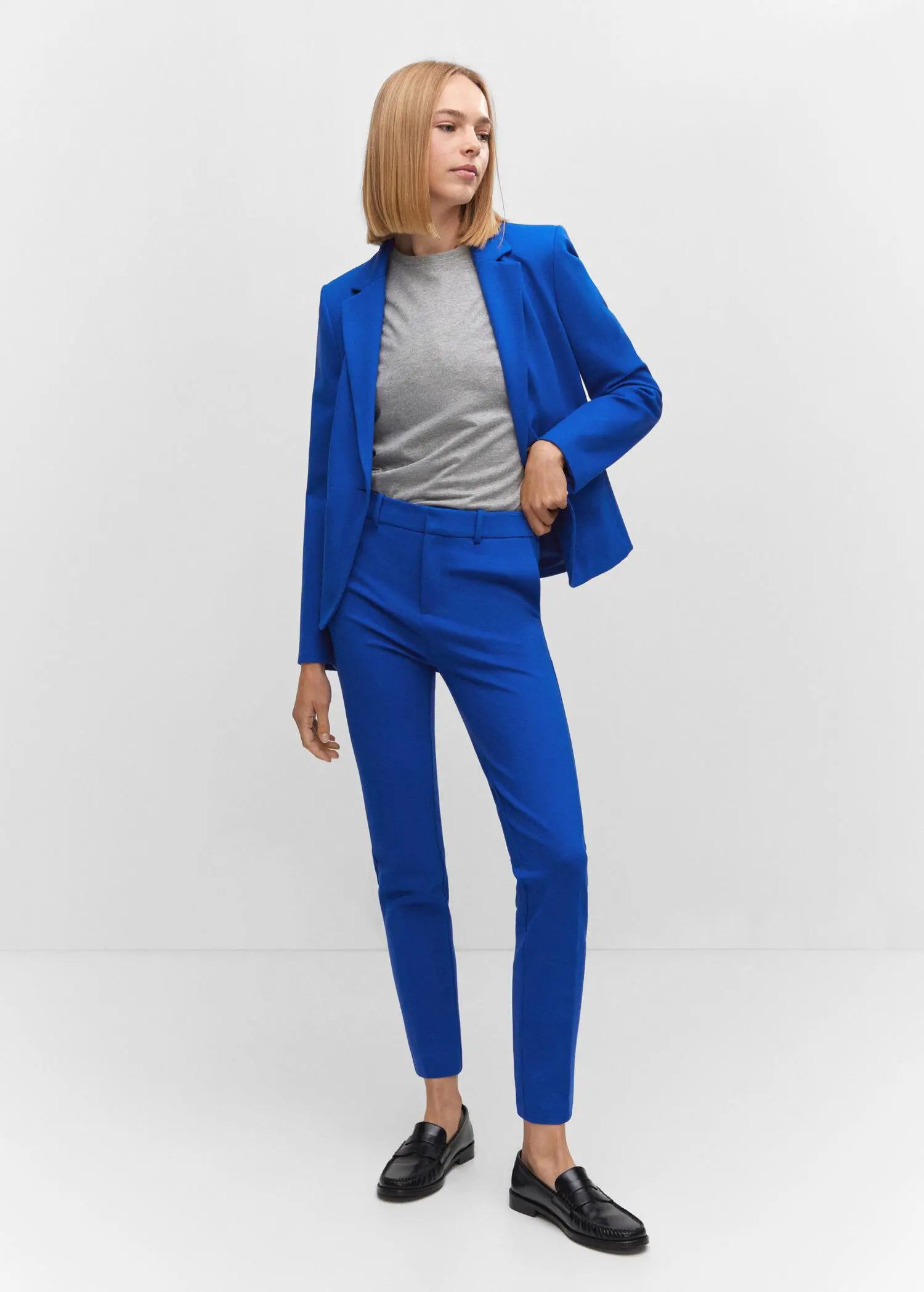 Mango Rome-knit straight pants. a woman wearing a blue suit standing in front of a white wall. 