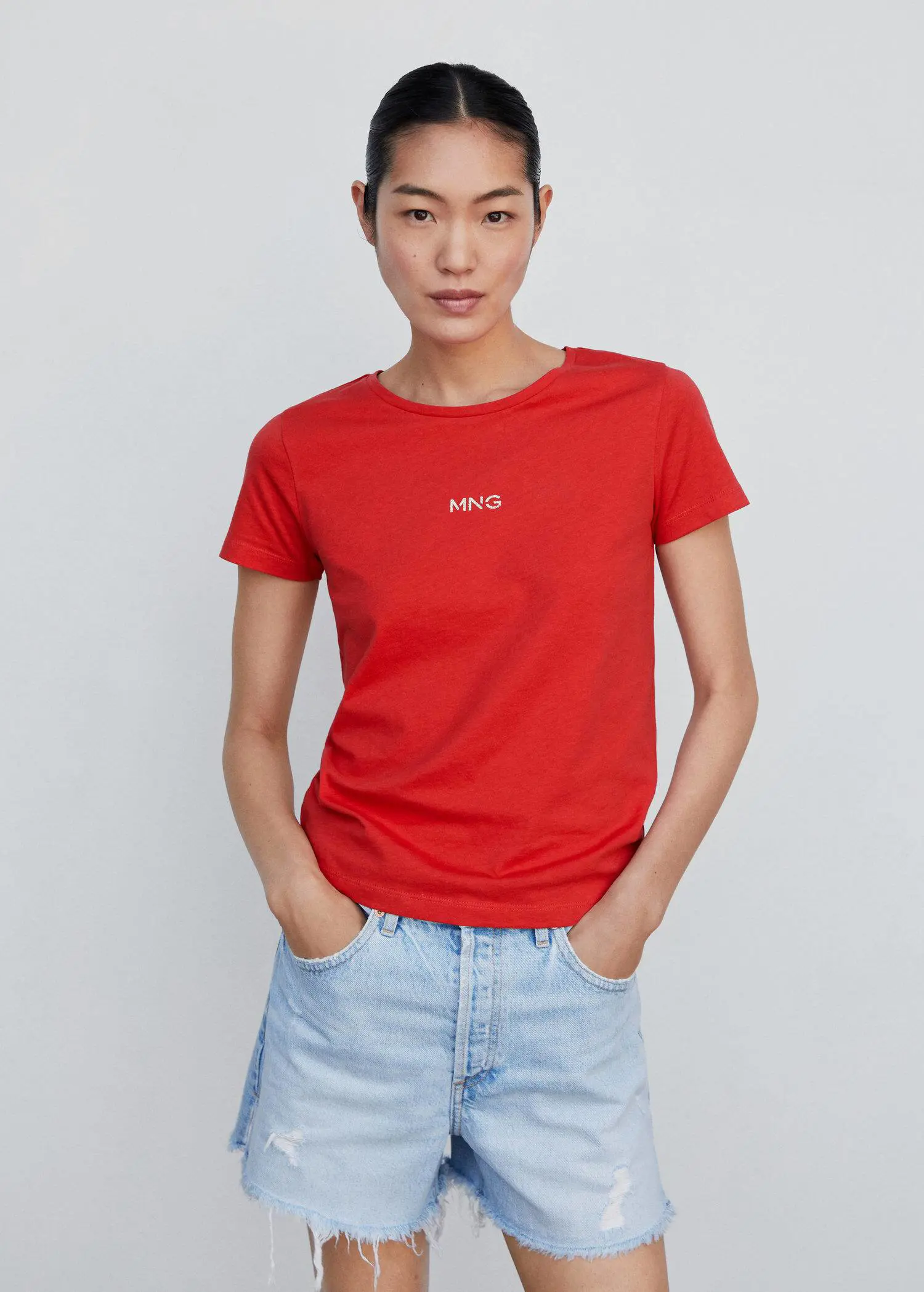 Mango Metallic logo T-shirt. a person wearing a red shirt and jeans. 