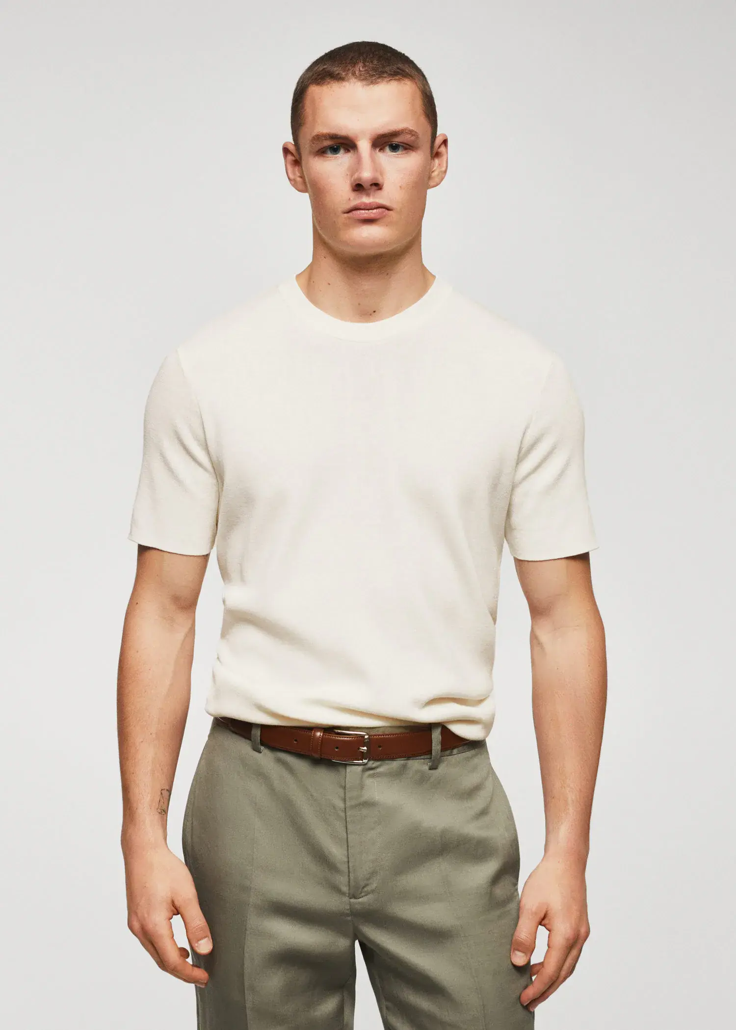 Mango Cotton fine-knit t-shirt. a man wearing a white shirt and a brown belt. 
