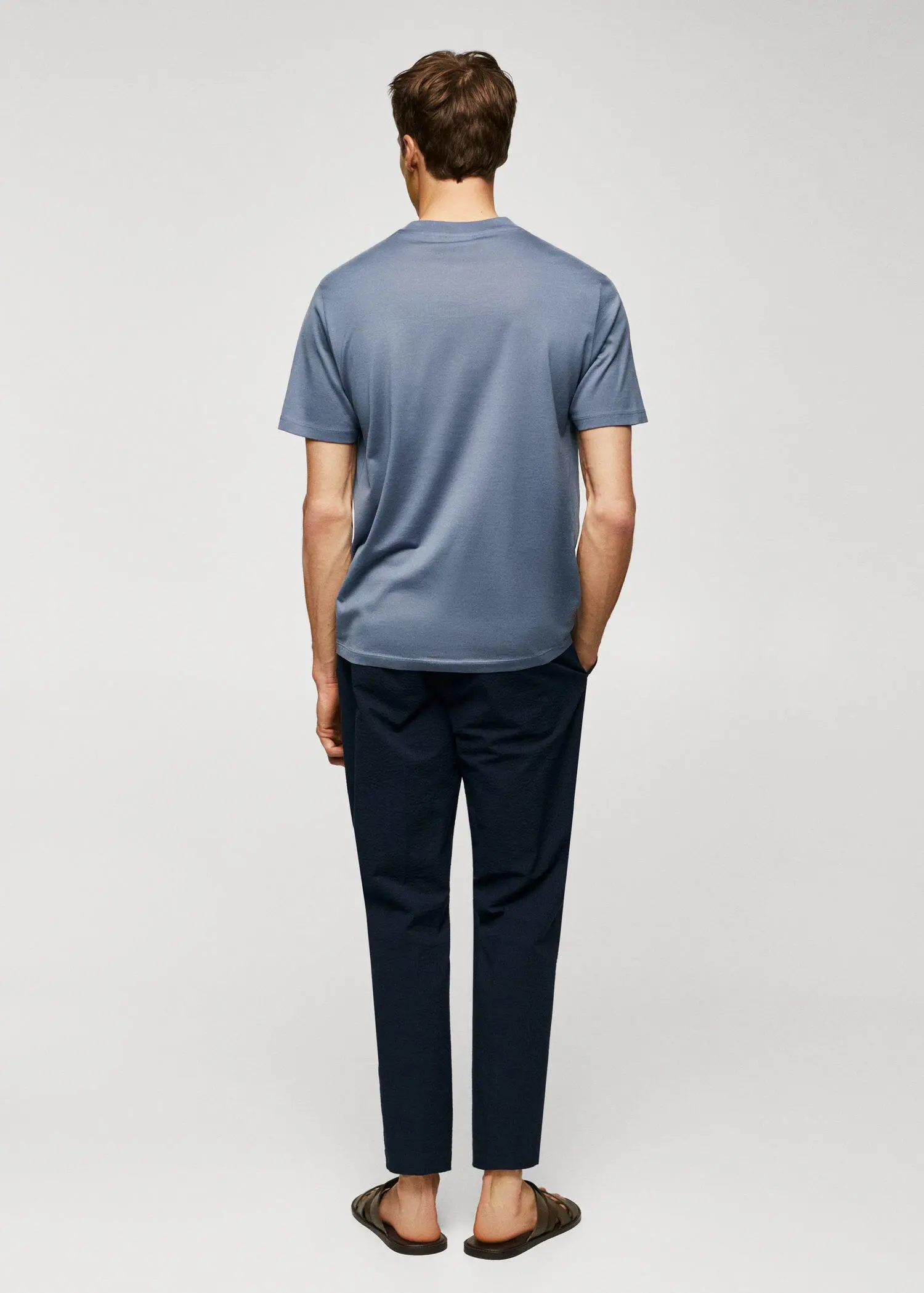 Mango Mercerised regular-fit t-shirt. a man wearing a blue shirt and black pants. 