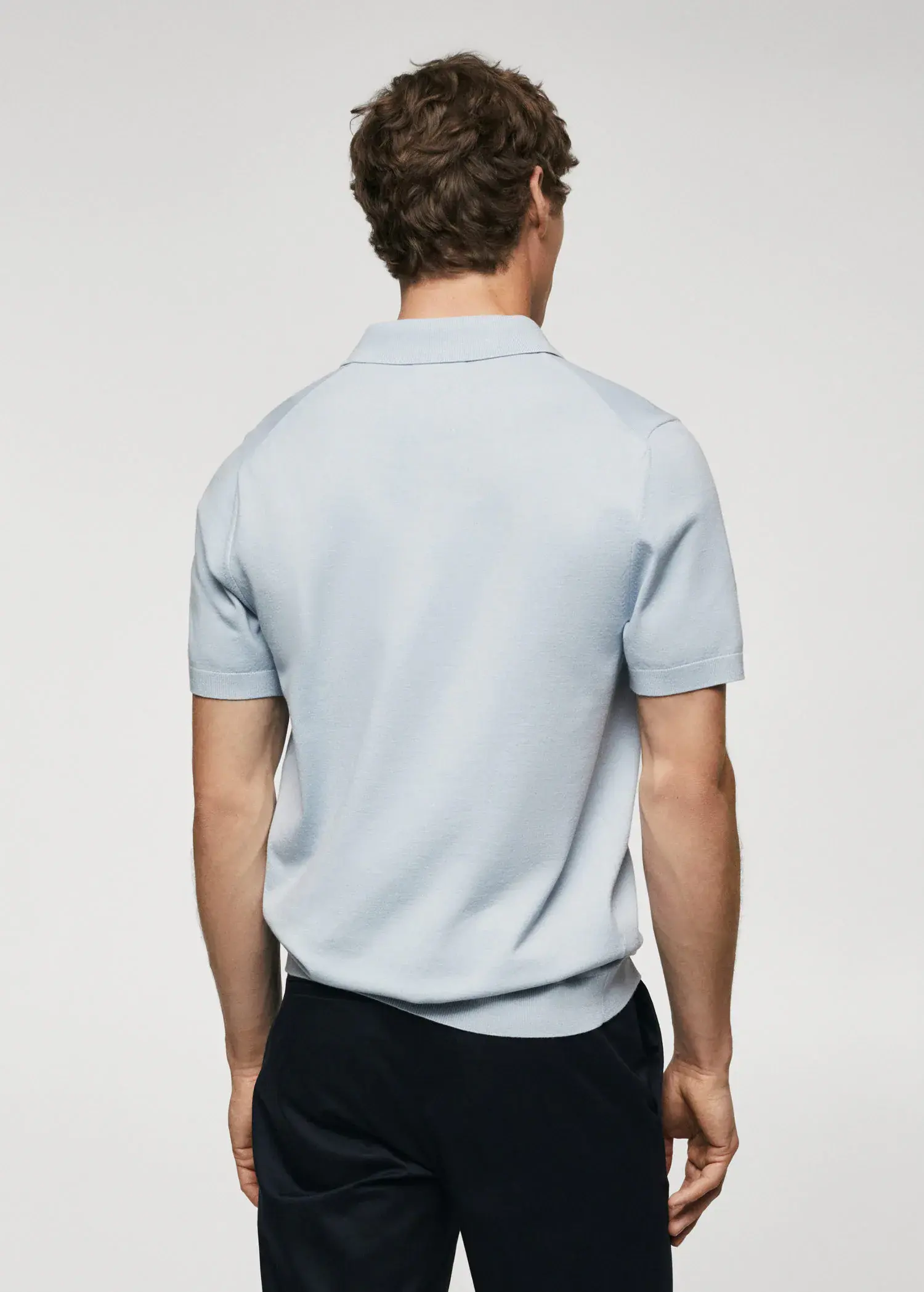 Mango Fine-knit polo shirt. a man wearing a light blue polo shirt. 