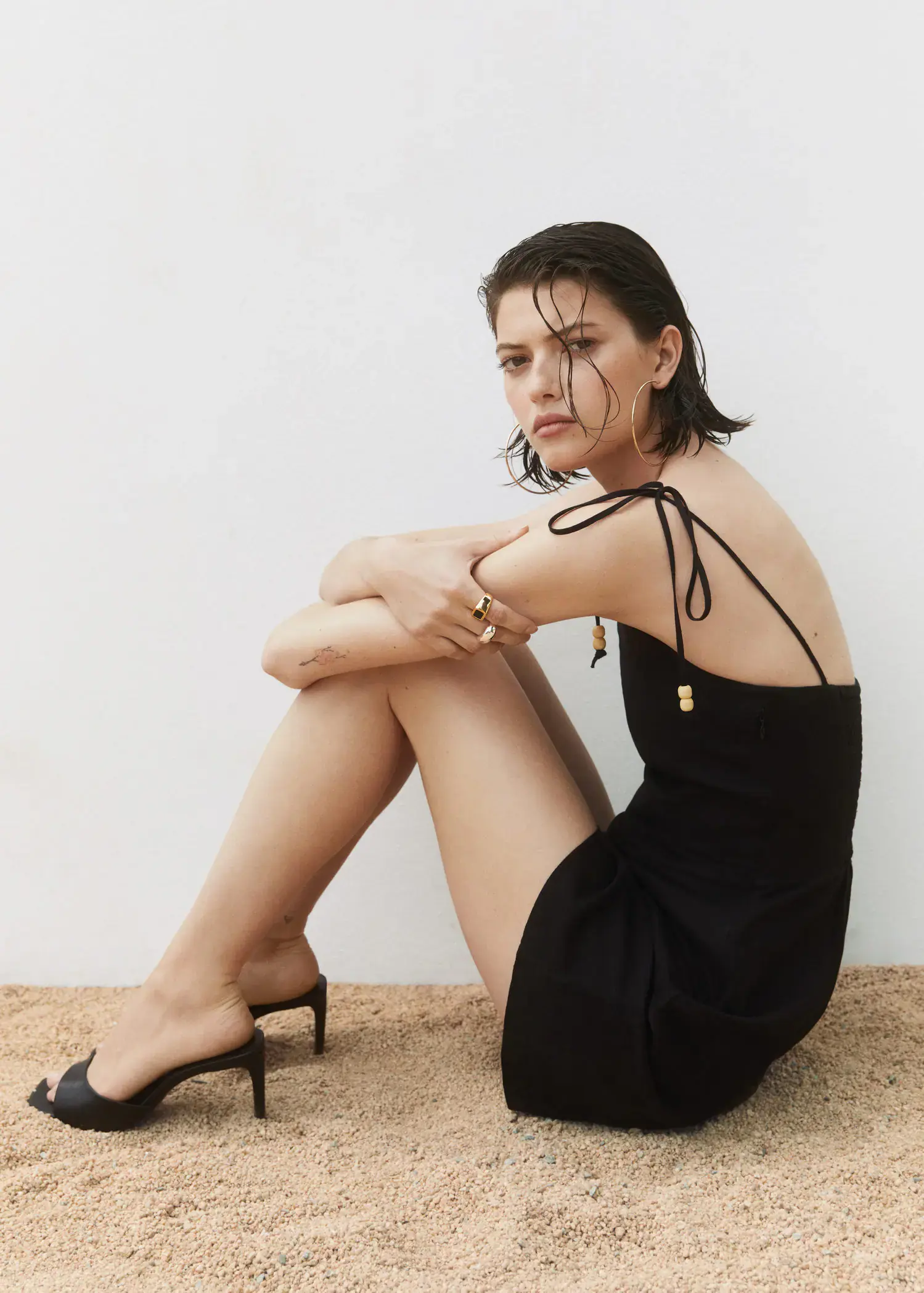 Mango Strappy heeled sandals. a woman sitting on the ground wearing a black dress. 