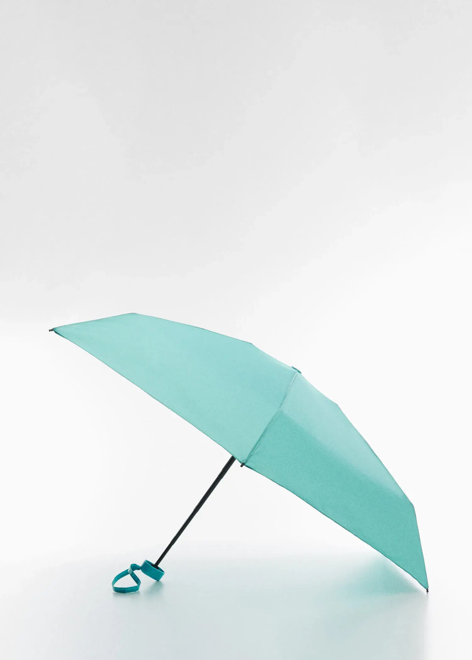 Mango Mini folding umbrella. an open umbrella is shown in the air. 