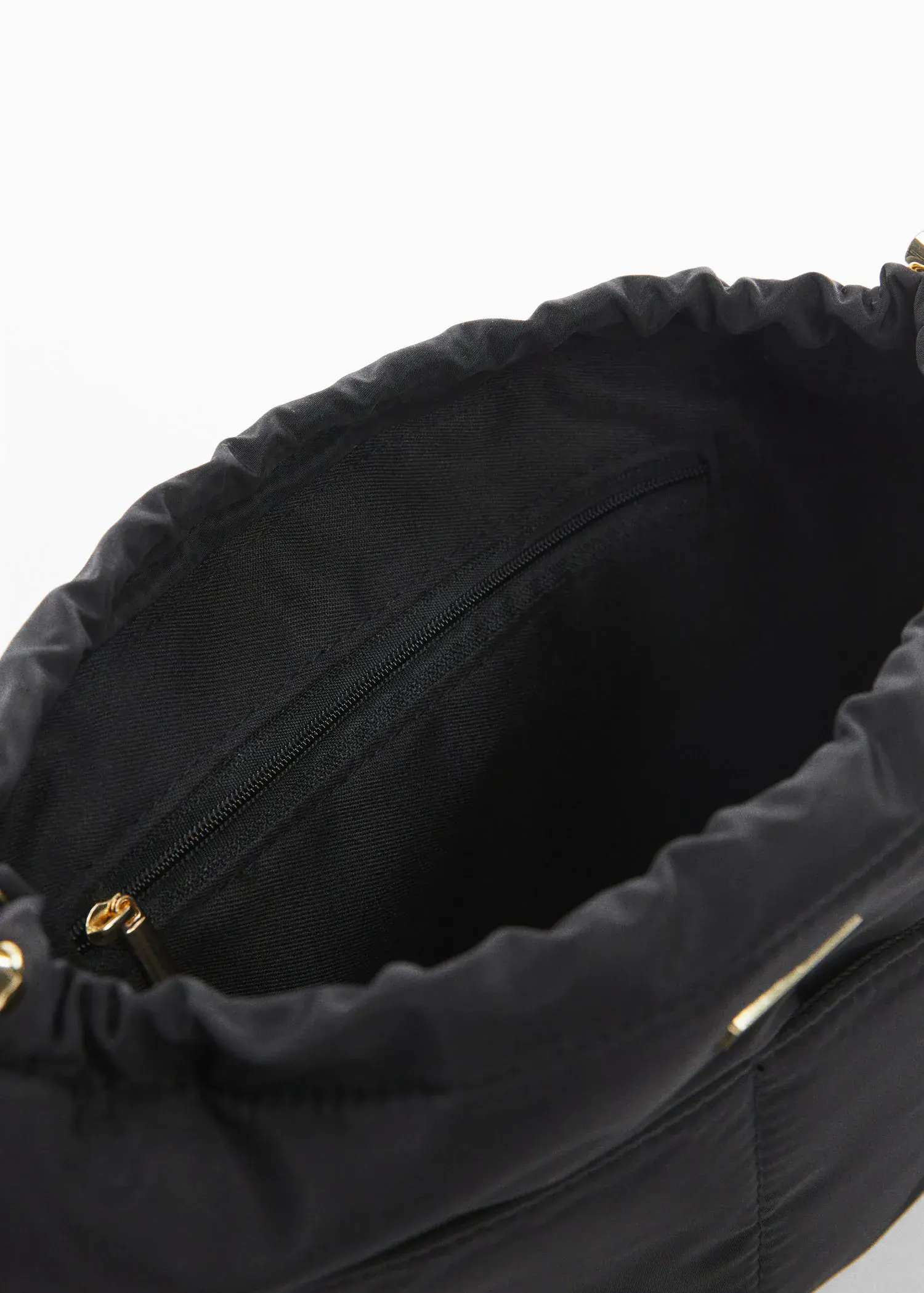 Mango Leather bowling bag. a close-up view of the inside of a black purse. 