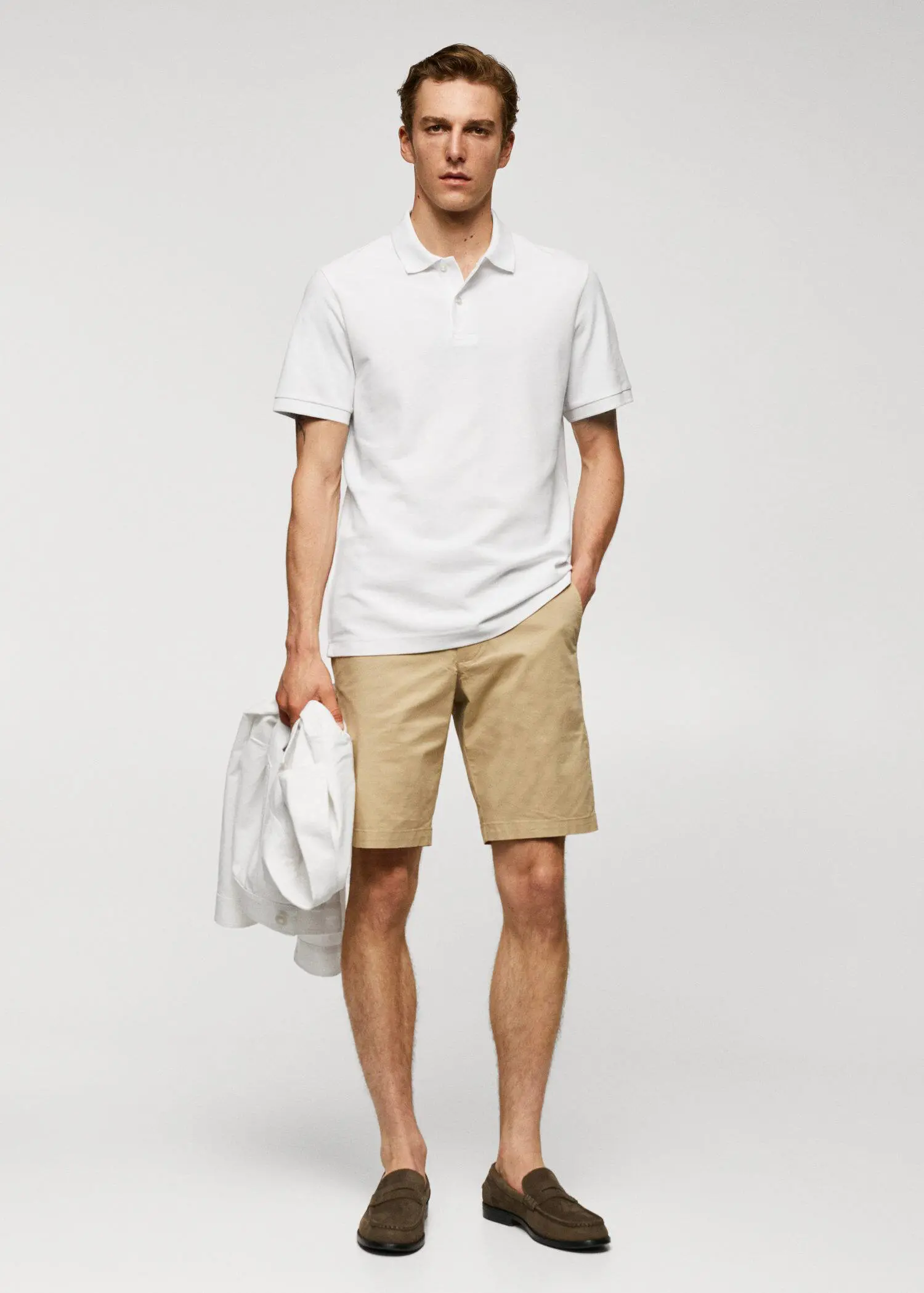 Mango 100% cotton pique polo shirt. a man in a white shirt and tan shorts. 