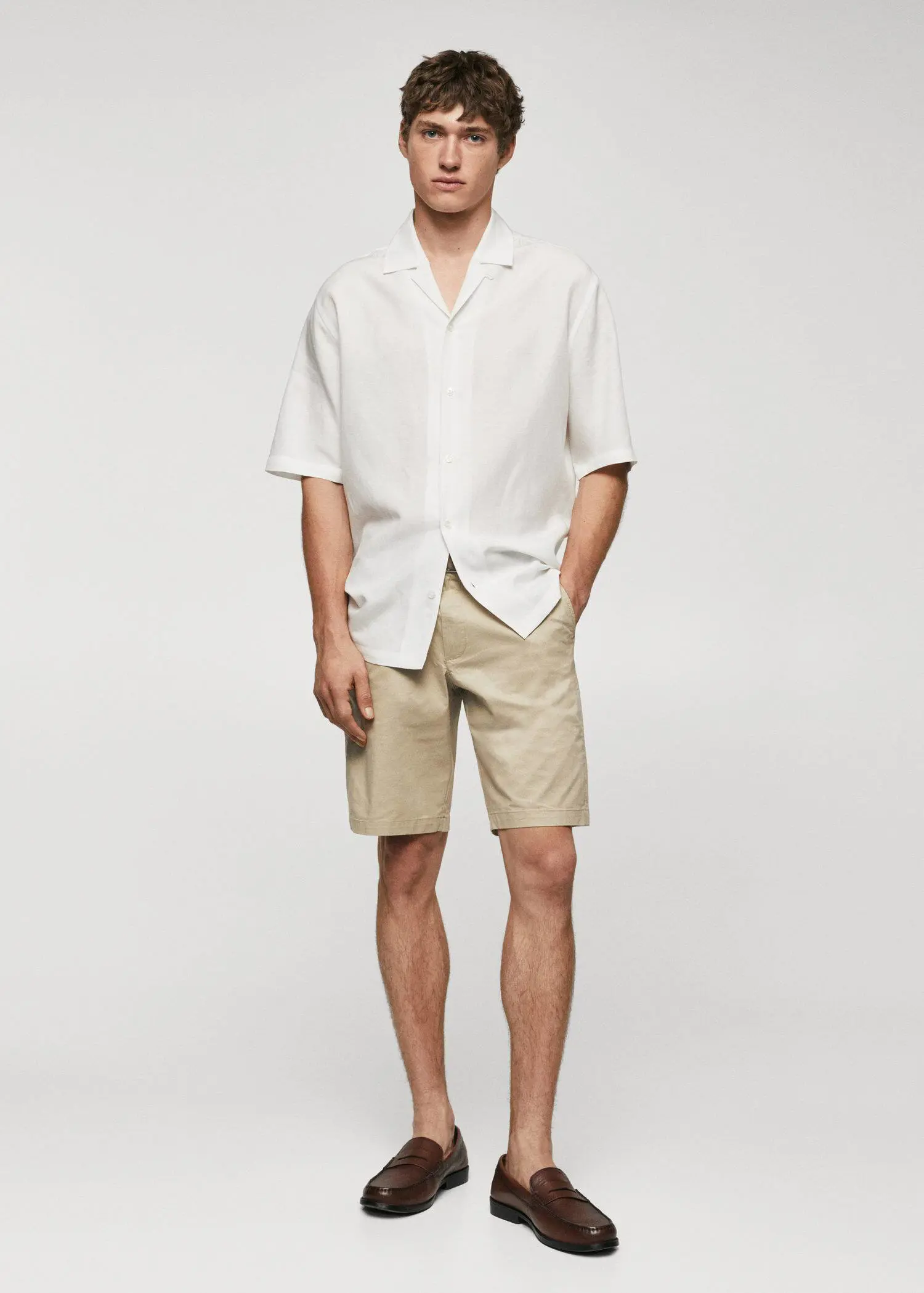 Mango Chino Bermuda shorts. a man in a white shirt and tan shorts. 