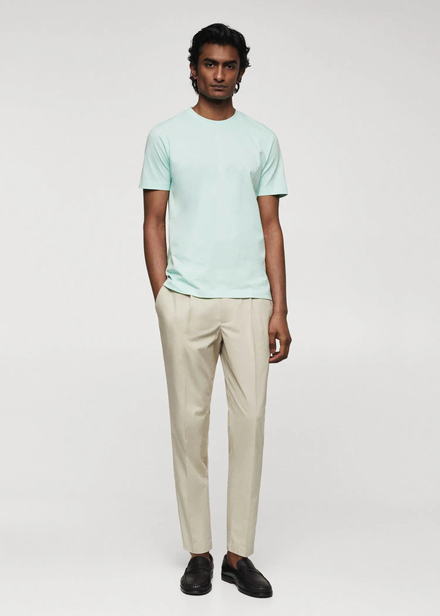Mango 100% cotton t-shirt . a man wearing a light blue shirt and beige pants. 