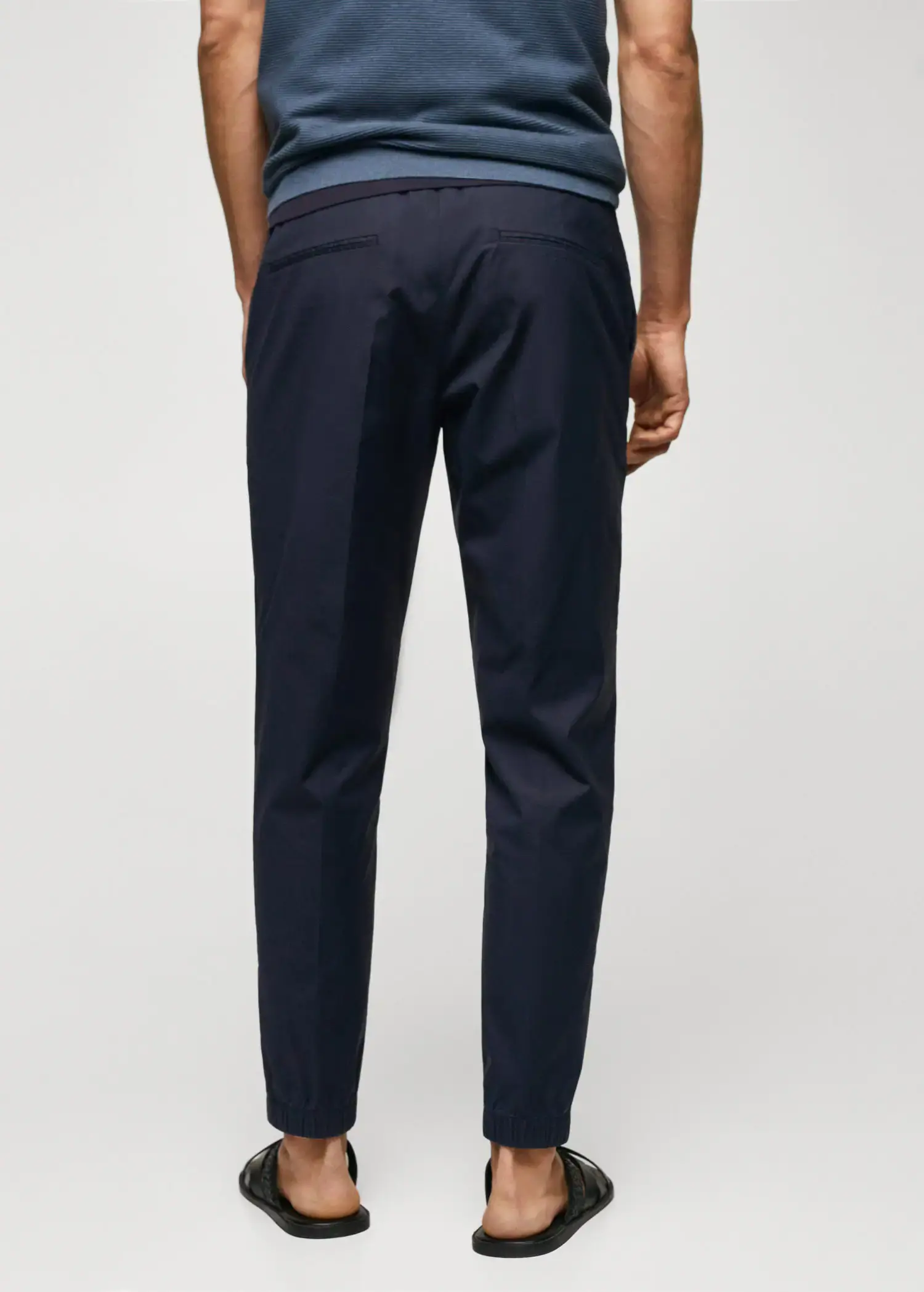 Mango Slim-fit cotton pants. a person wearing a pair of navy blue pants. 