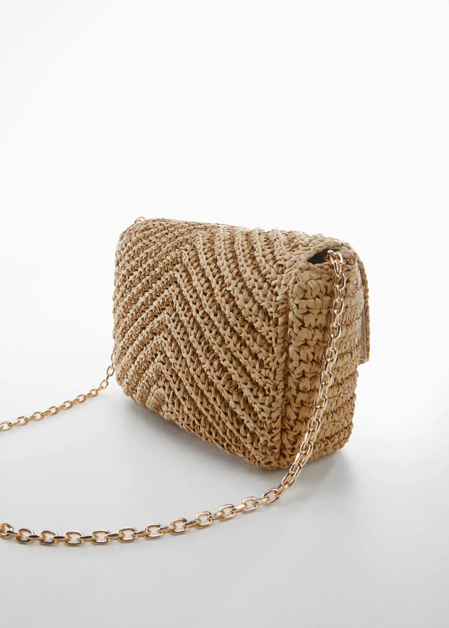 Mango Natural fiber bag with flap. a close-up of a straw purse on a white surface. 
