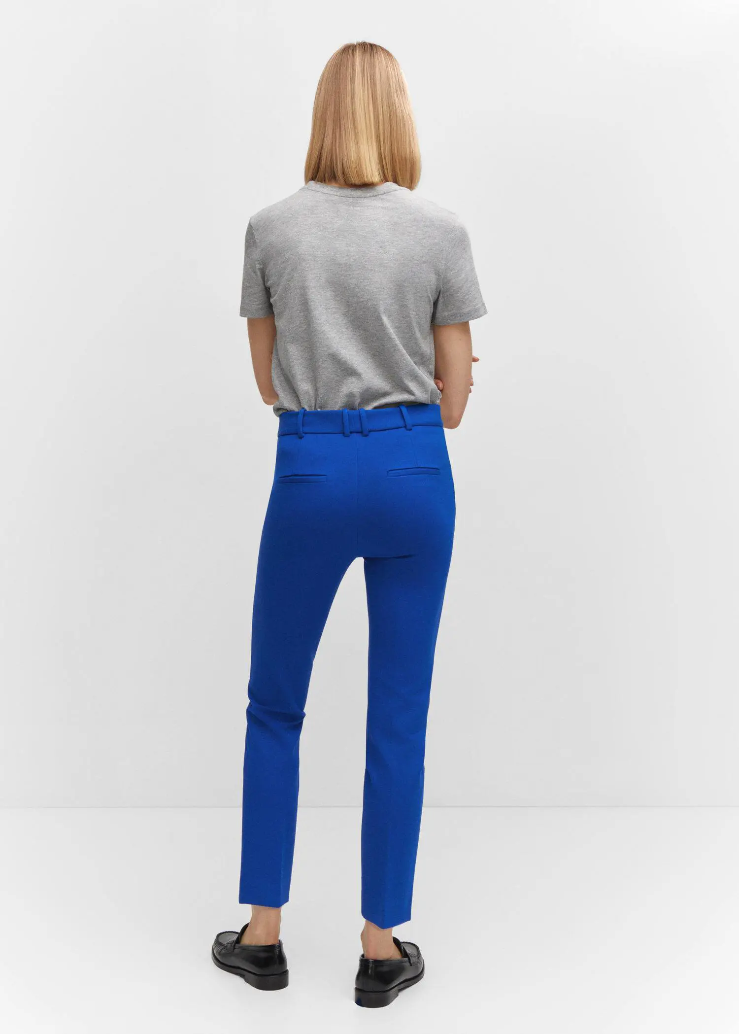 Mango Rome-knit straight pants. a person standing in front of a white wall. 