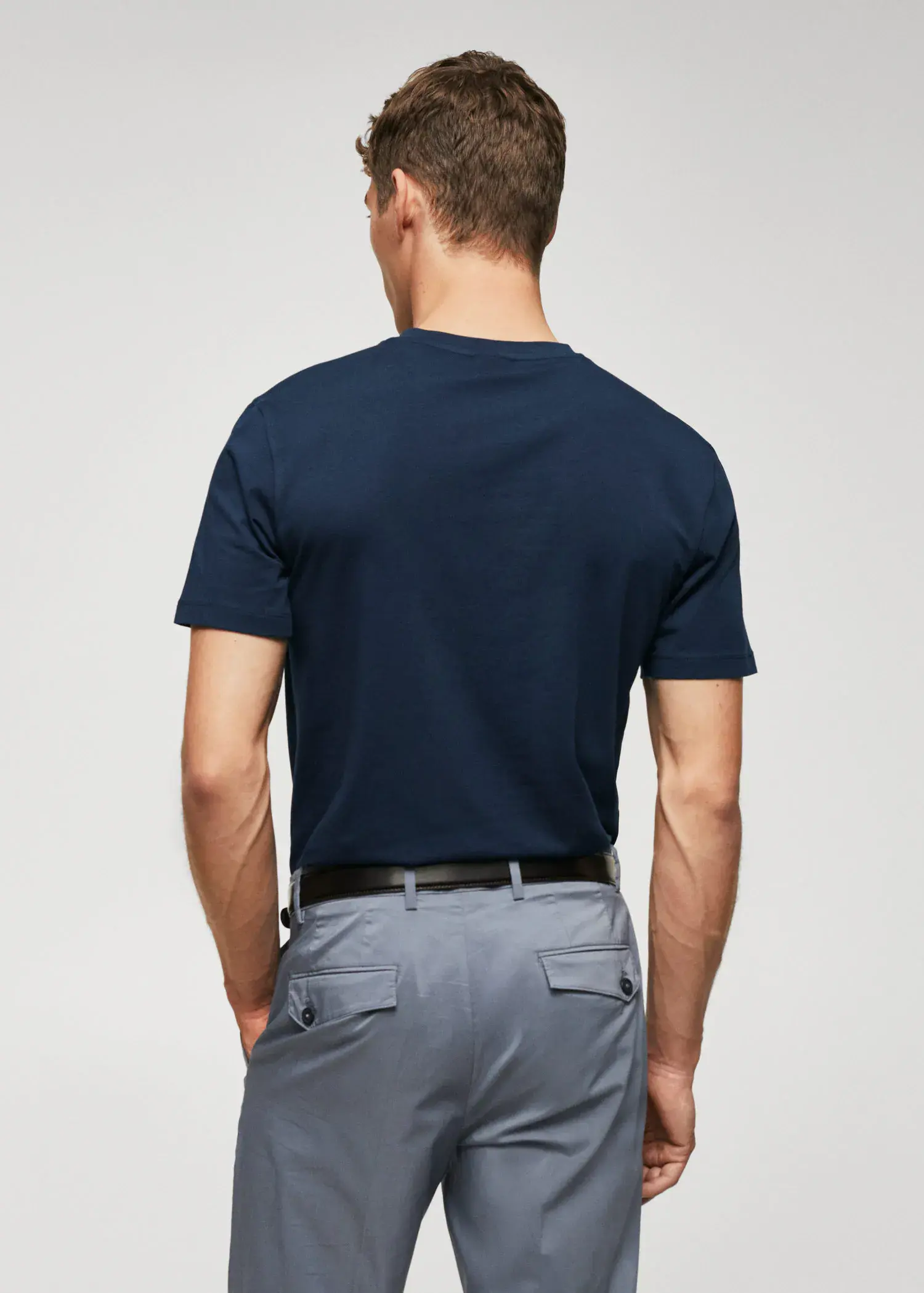 Mango Basic lightweight cotton t-shirt. a man wearing a blue shirt and gray pants. 