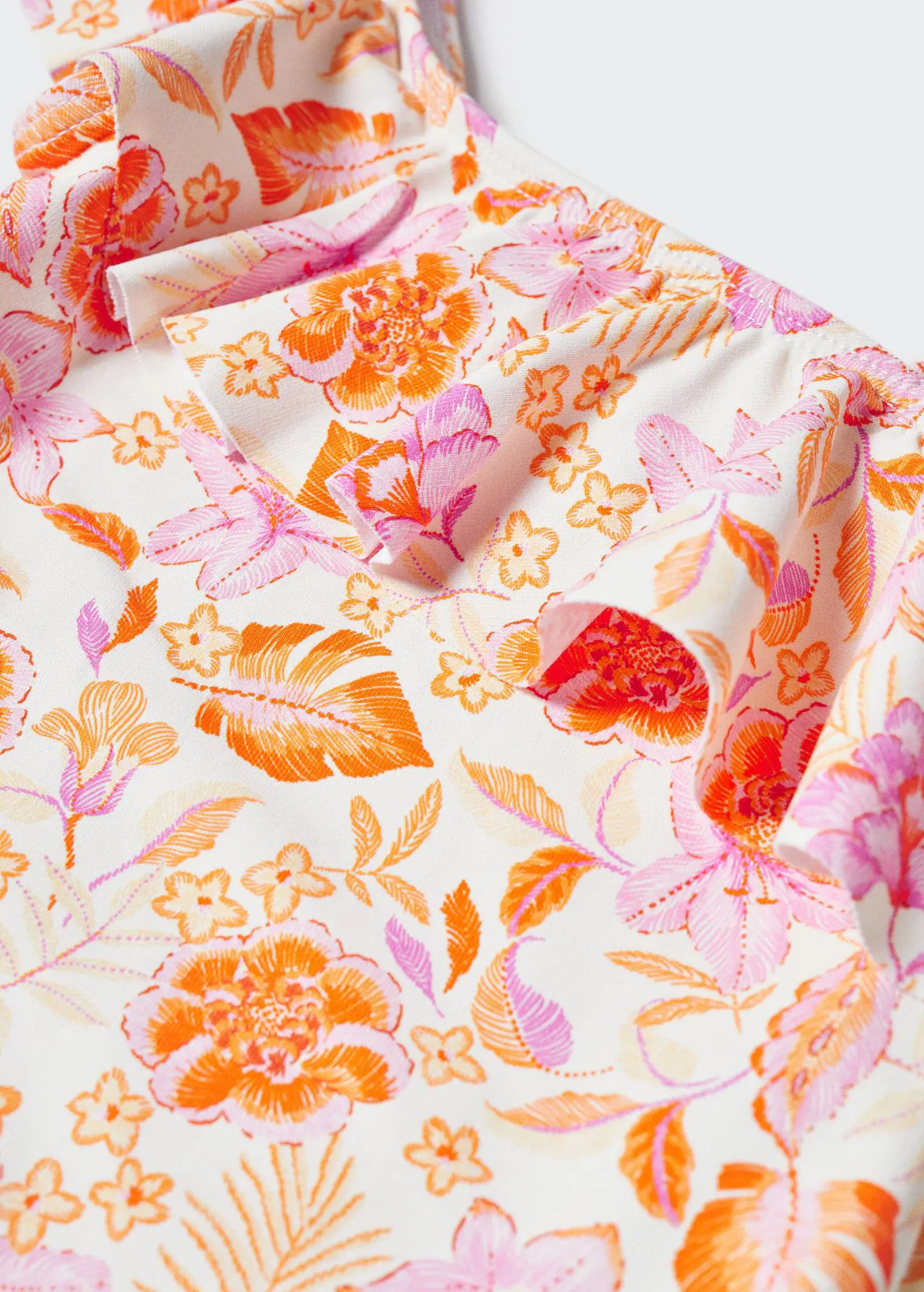 Mango Asymmetrical-print swimsuit. a close-up view of a floral pattern. 