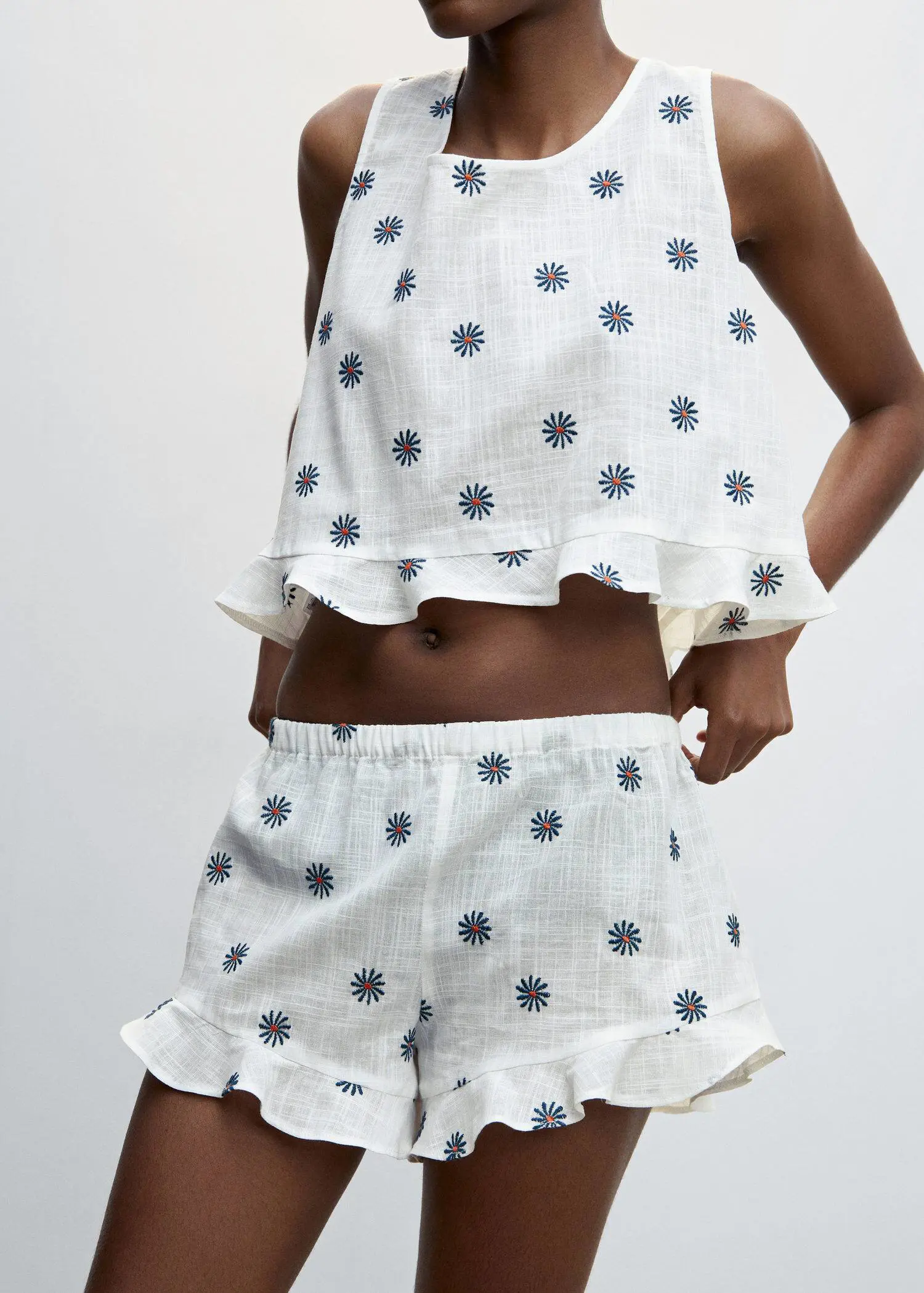 Mango Floral embroidered pajama shorts. a woman wearing a white outfit with blue and white flowers. 