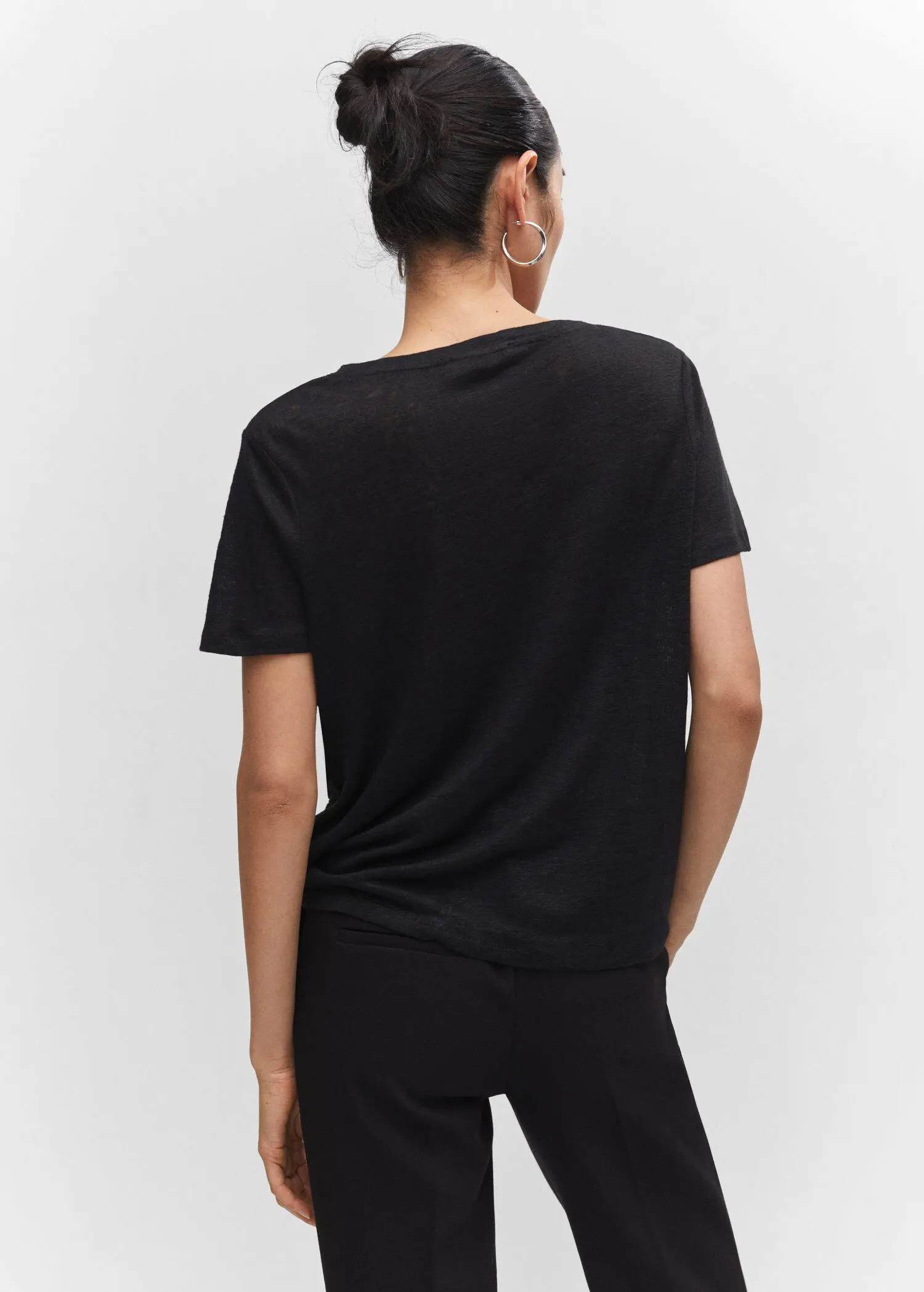 Mango V-neck linen t-shirt. a person wearing a black shirt and black shorts. 