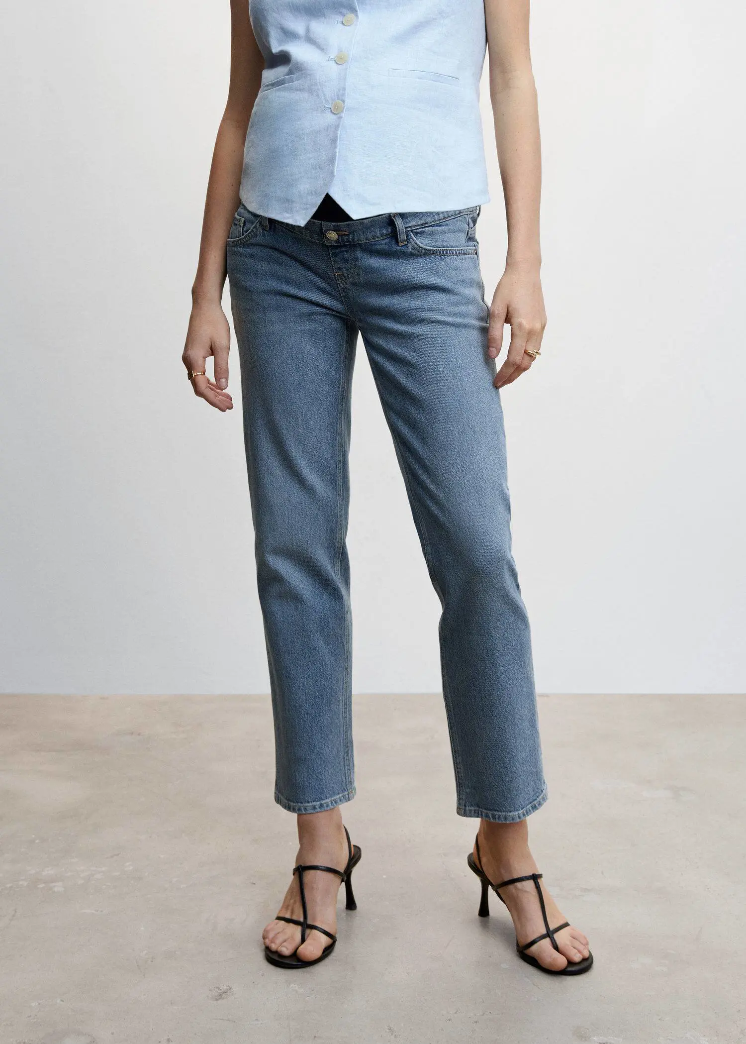 Mango Maternity Straight Jeans. a person wearing a pair of blue jeans and black heels. 