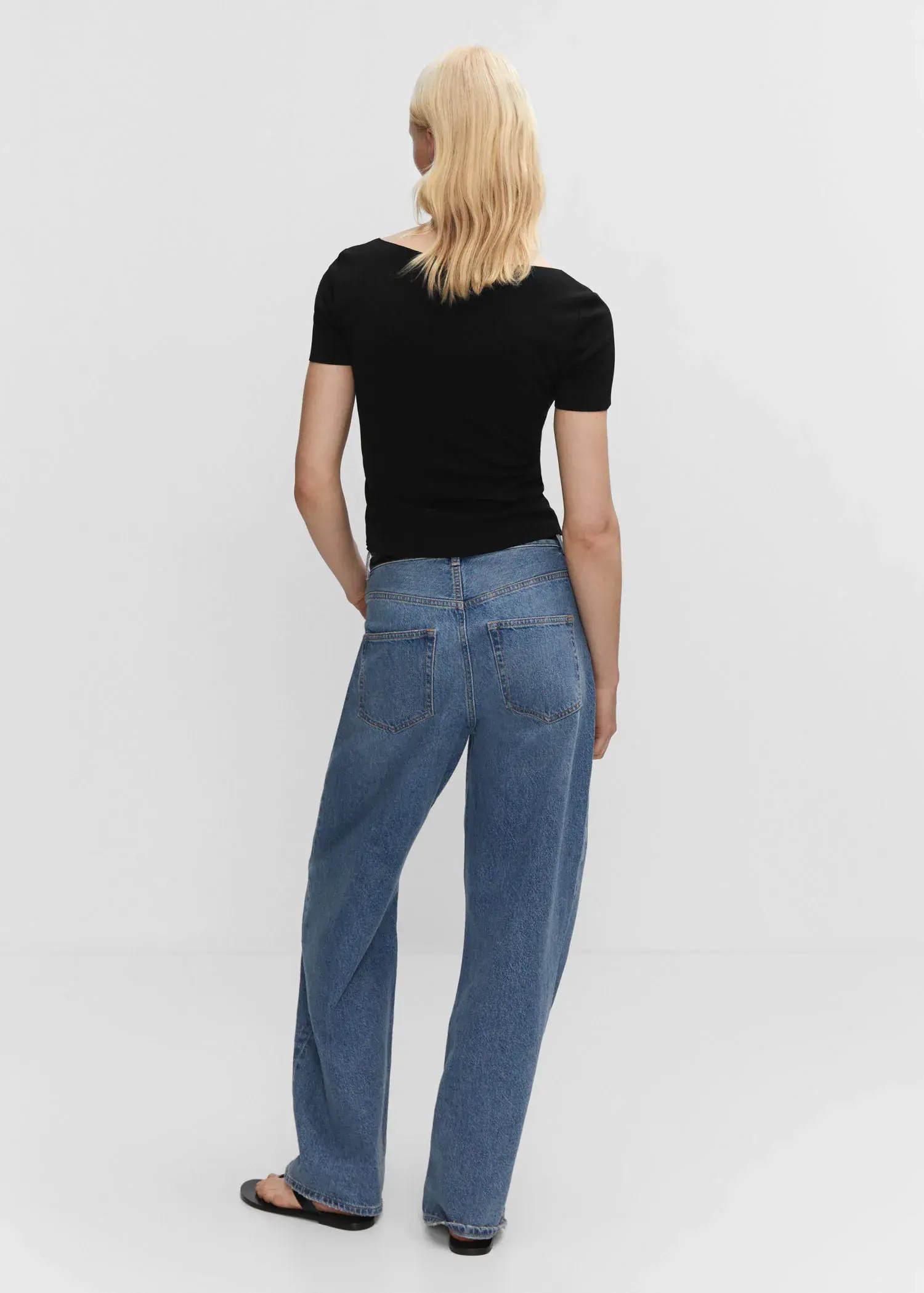 Mango Square neck t-shirt. a woman wearing a black shirt and blue jeans. 