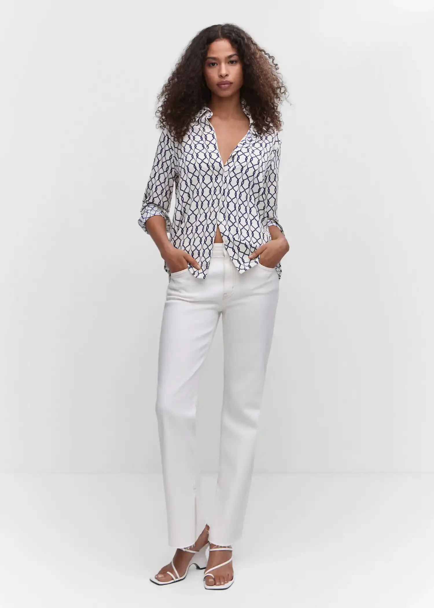 Mango Regular flowy shirt. a woman wearing white pants and a white shirt. 