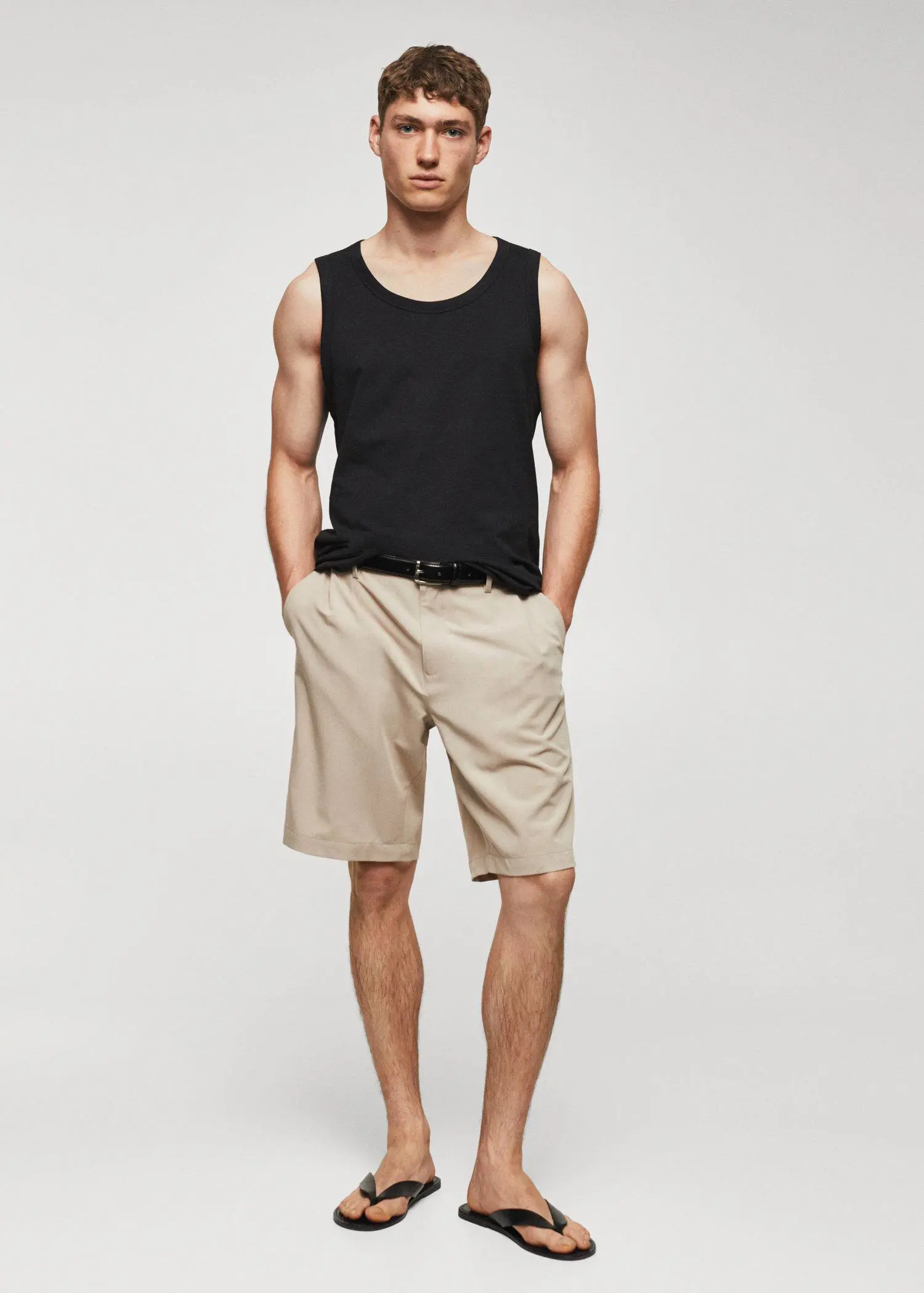 Mango Strap cotton T-shirt. a man in black tank top and beige shorts. 