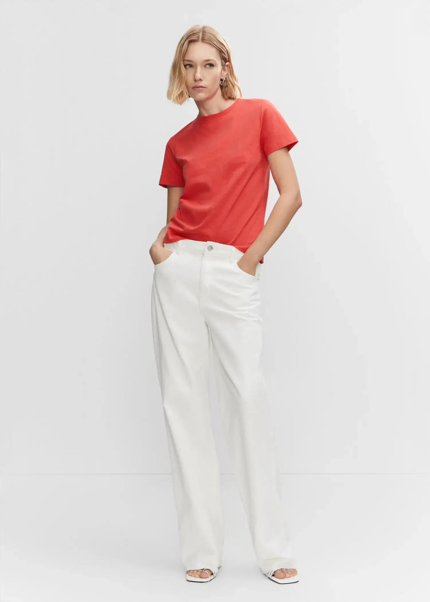 Mango 100% cotton T-shirt. a woman wearing a red shirt and white pants. 