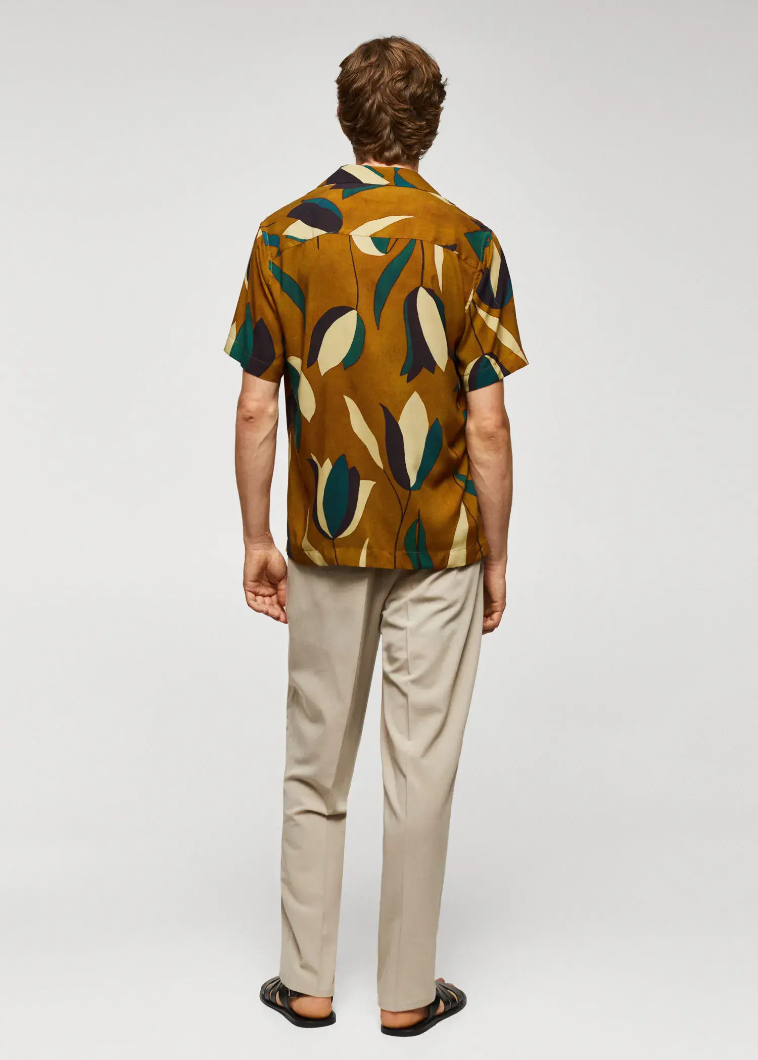 Mango Printed bowling shirt. a man wearing a brown shirt and beige pants. 