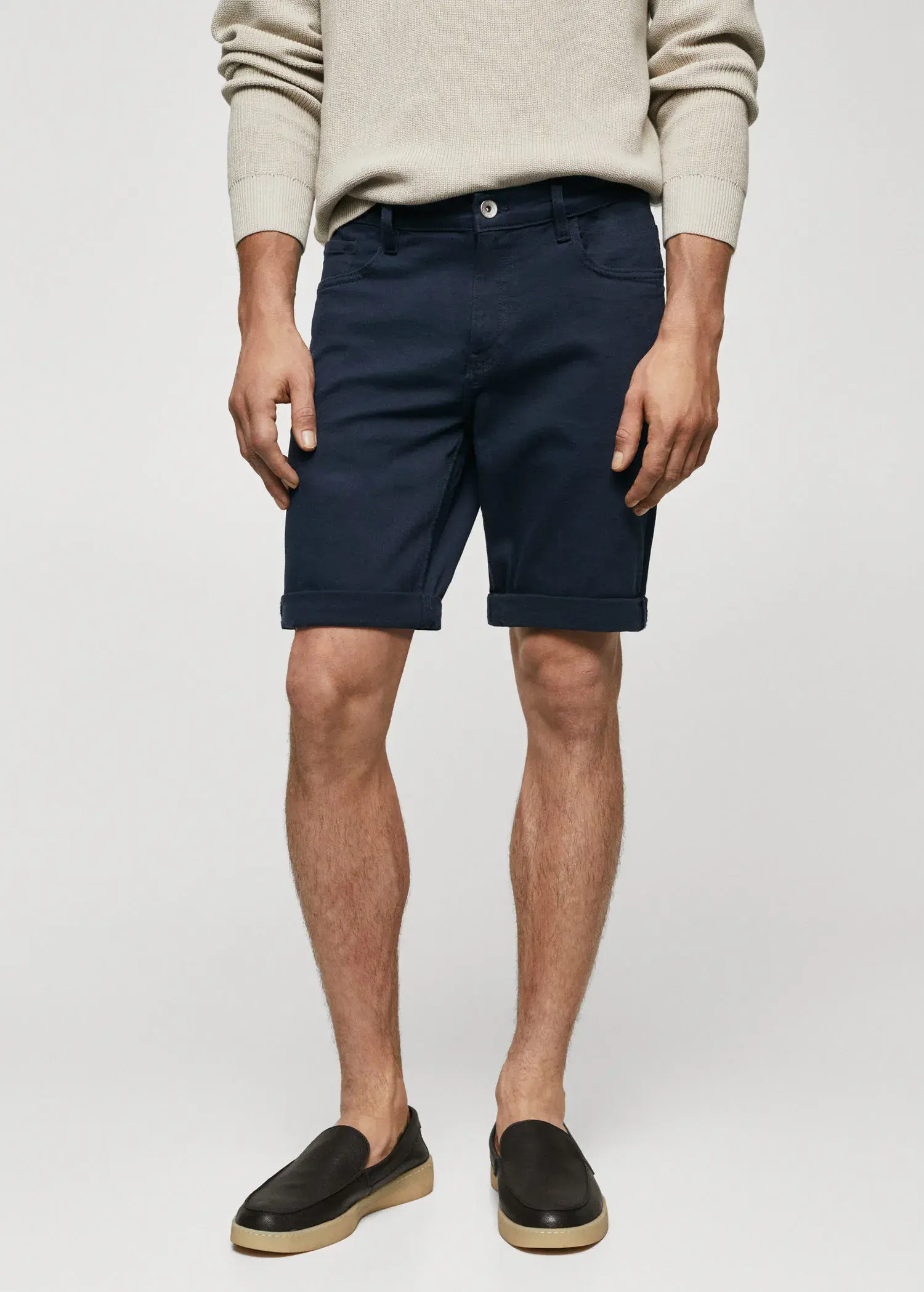 Mango Slim-fit denim bermuda shorts. a man wearing a pair of navy blue shorts. 