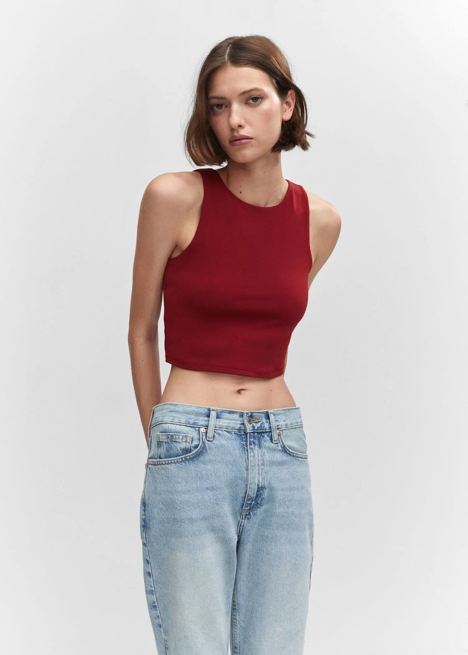 Mango Crop top with halter neck. a woman wearing a red top and jeans. 