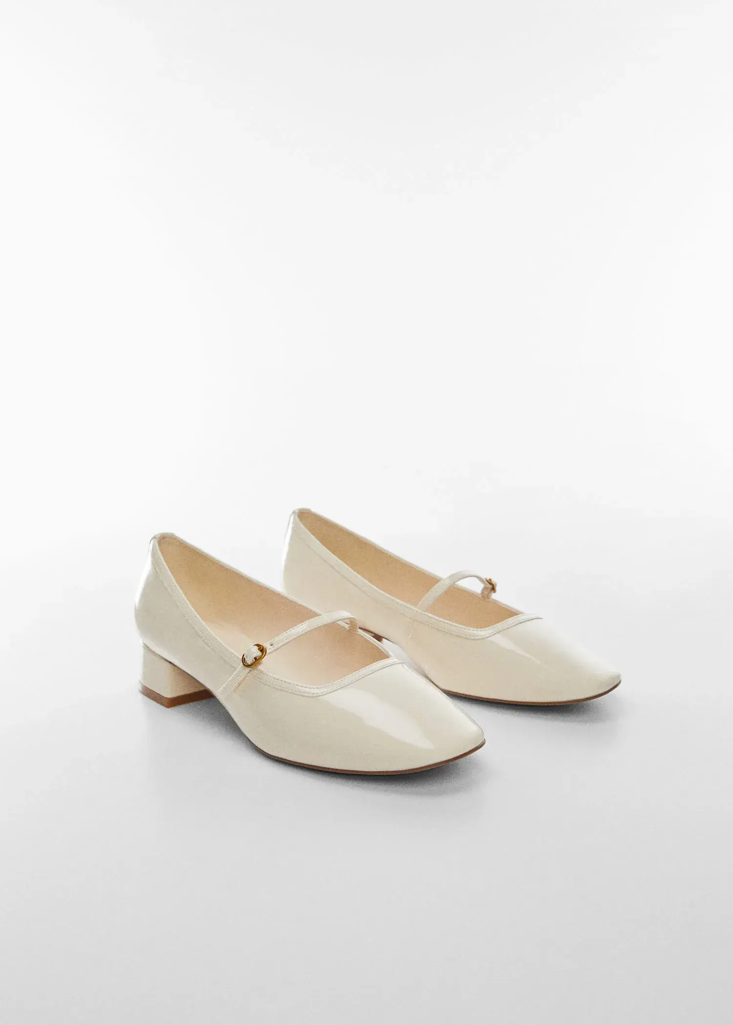 Mango Buckle heel shoes. a pair of shoes that are on the ground. 