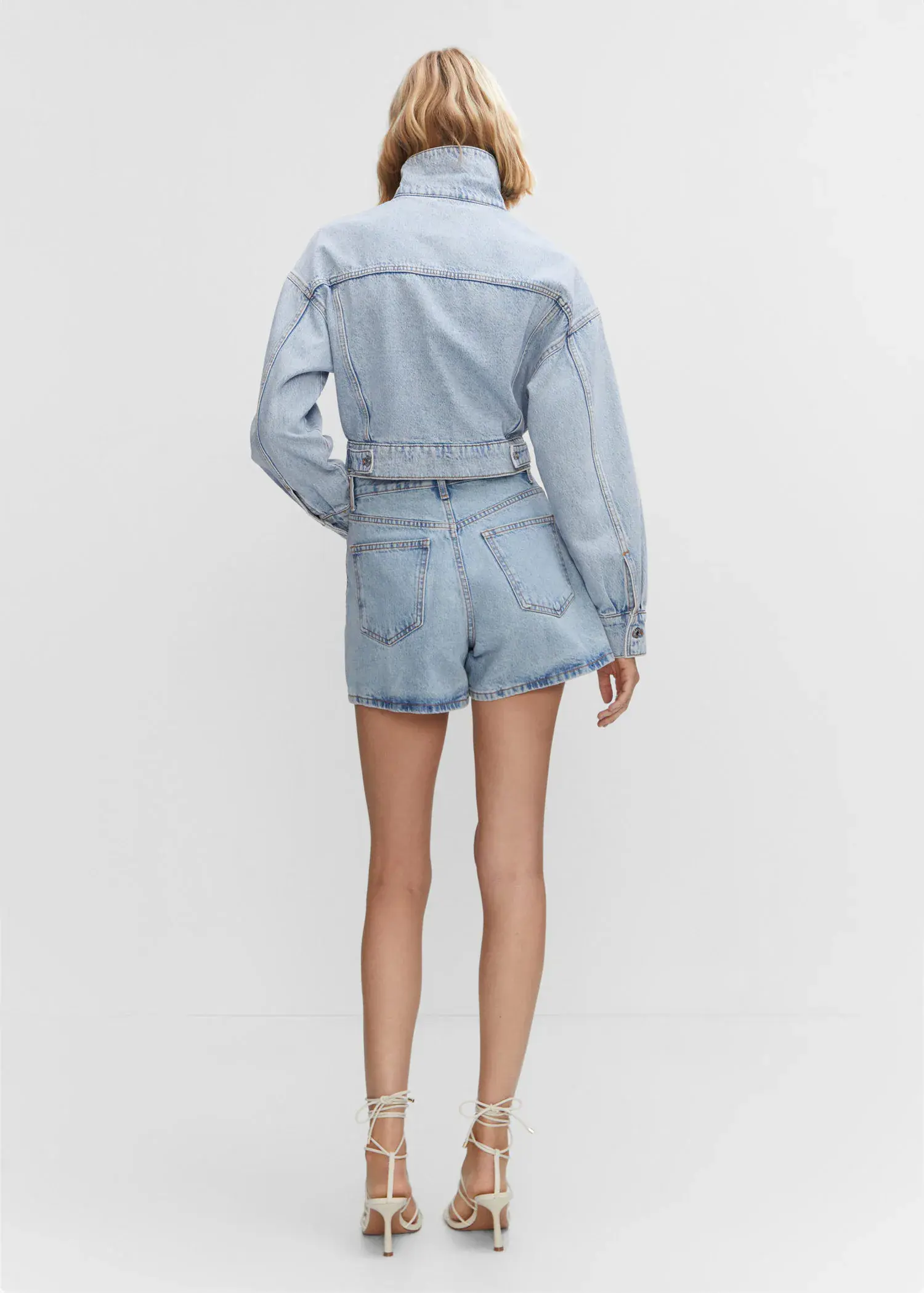 Mango Cropped denim jacket. a person wearing a short and a jacket. 