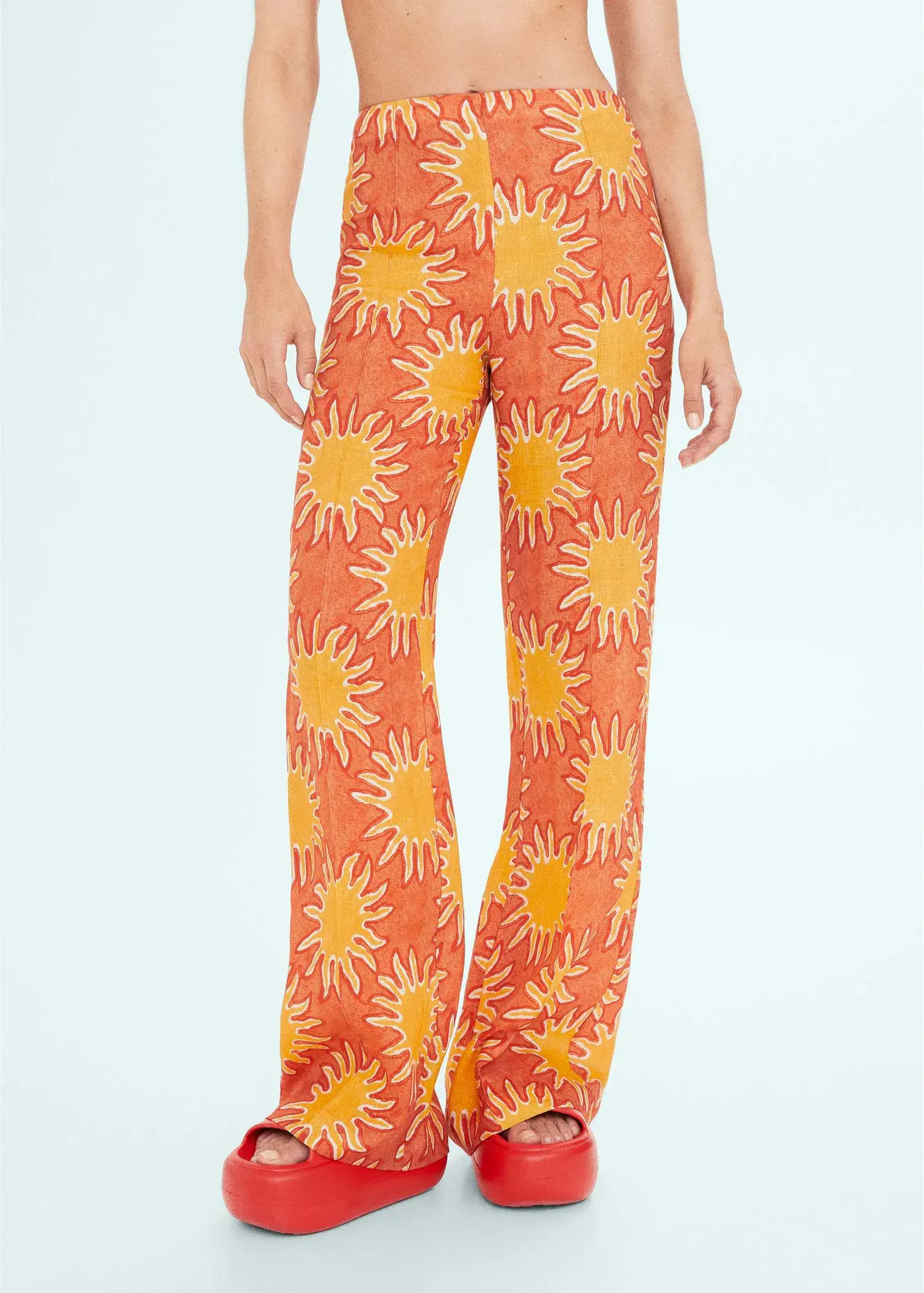 Mango Printed linen wideleg pants. a person standing wearing a pair of pants. 