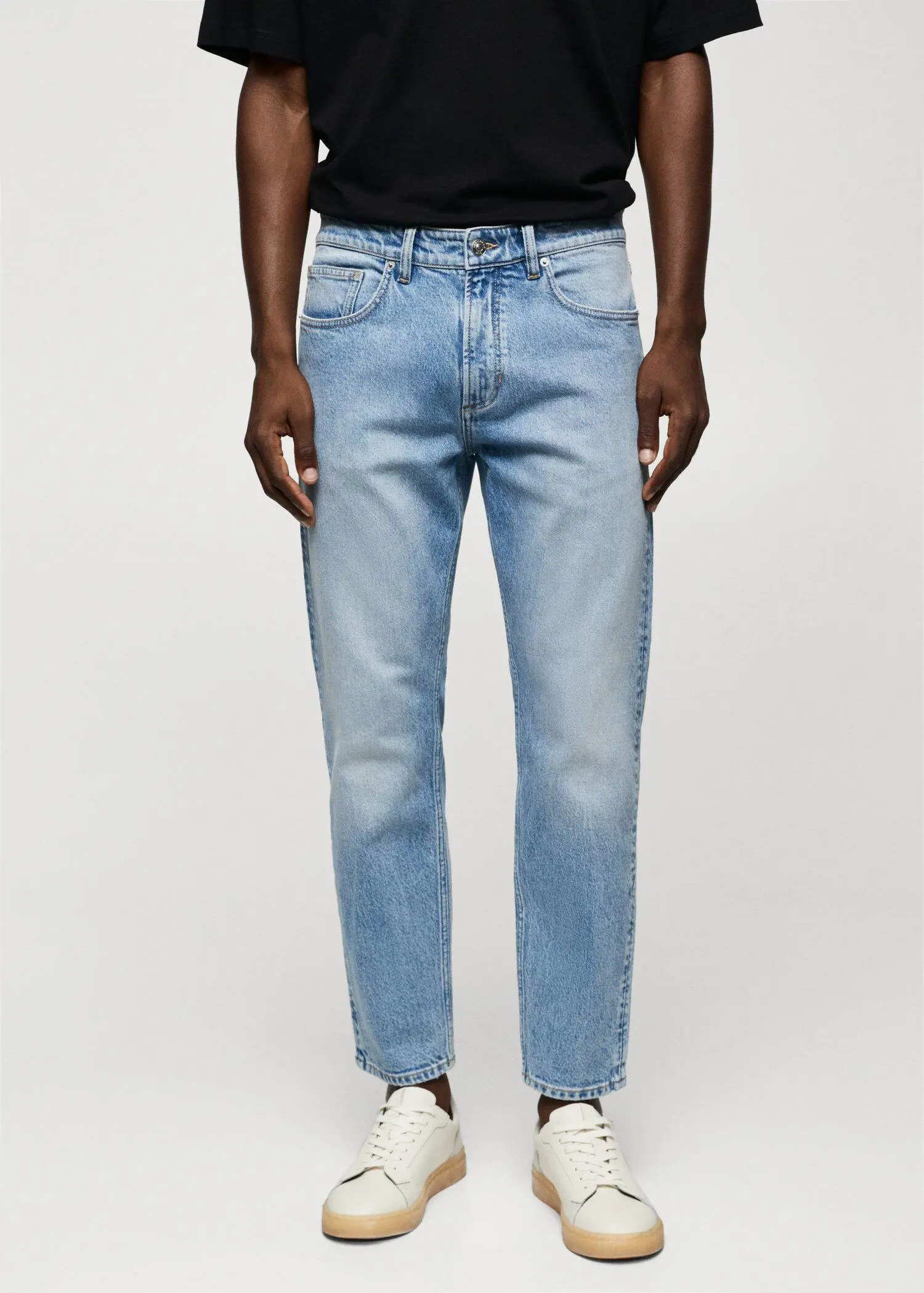 Mango Ben tapered cropped jeans. a person wearing a pair of light blue jeans. 