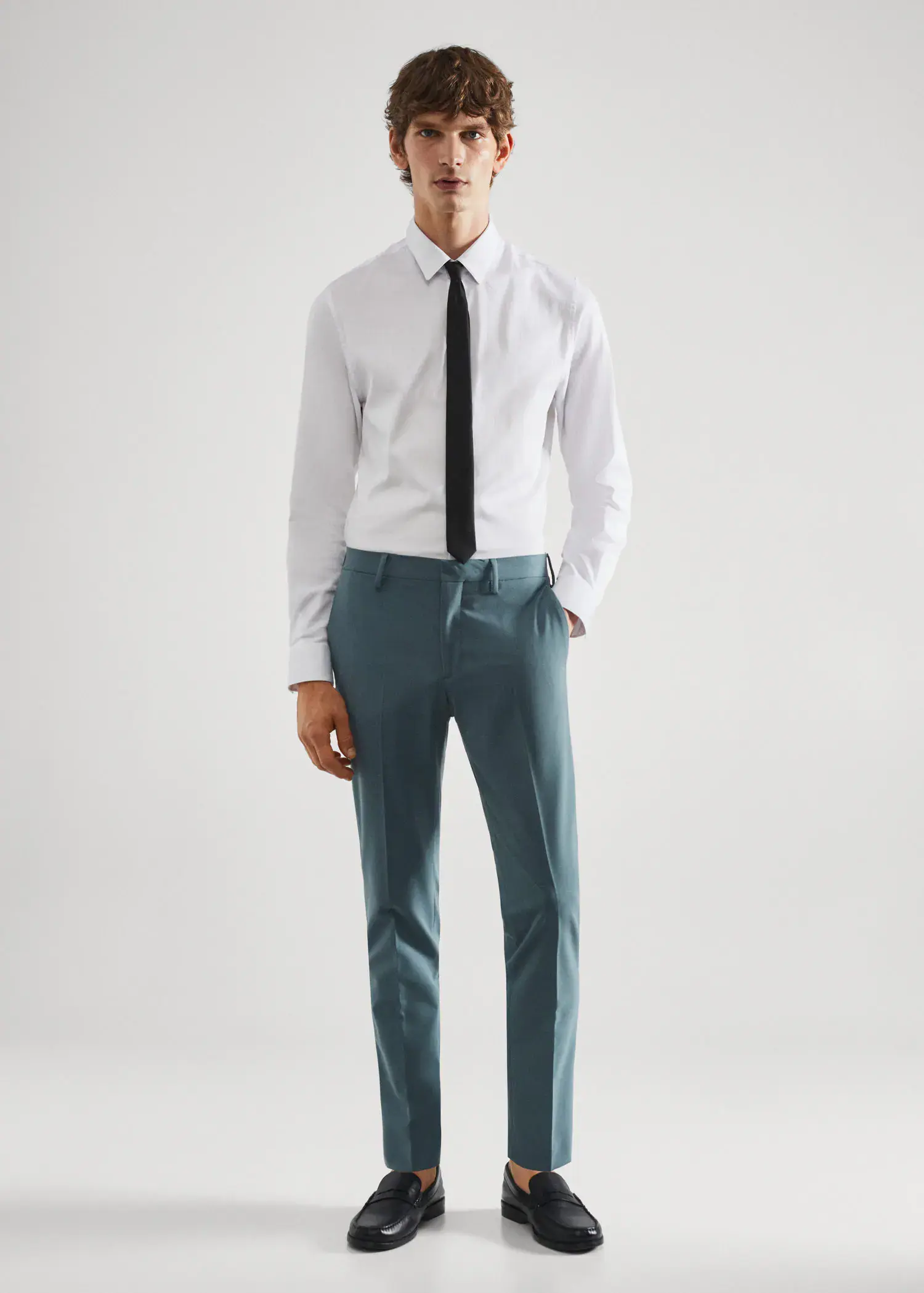 Mango Stretch fabric super slim-fit suit pants. a man in a white shirt and blue pants. 