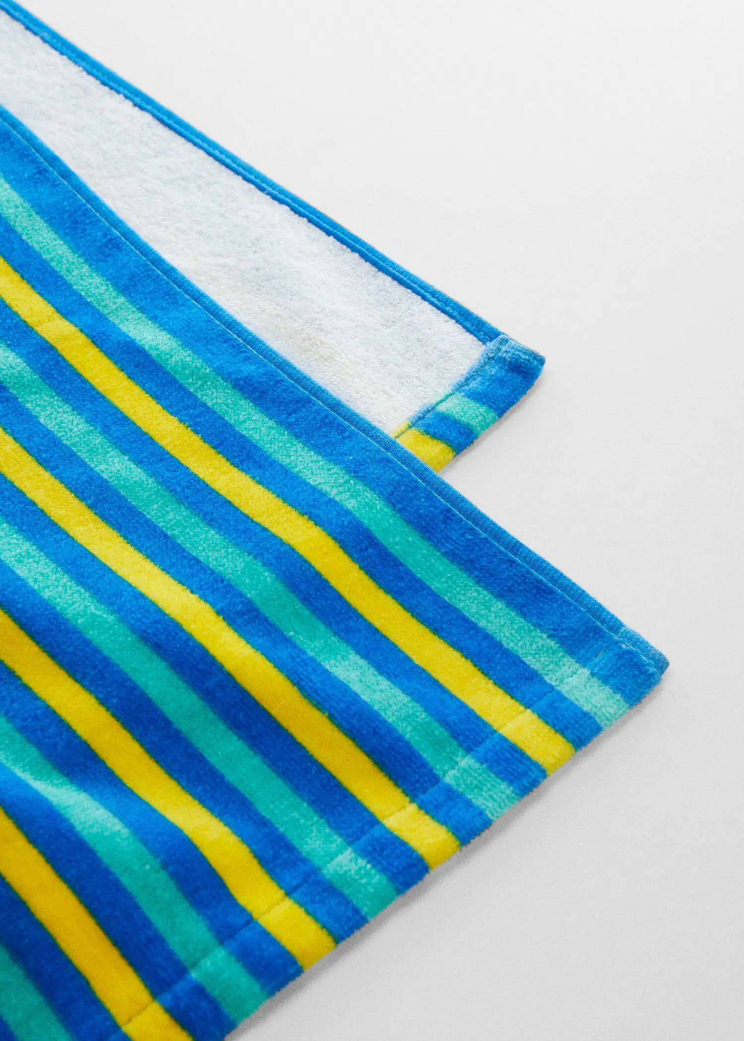Mango Multi-colored striped beach towel. a close-up view of a blue, yellow, and green striped towel. 