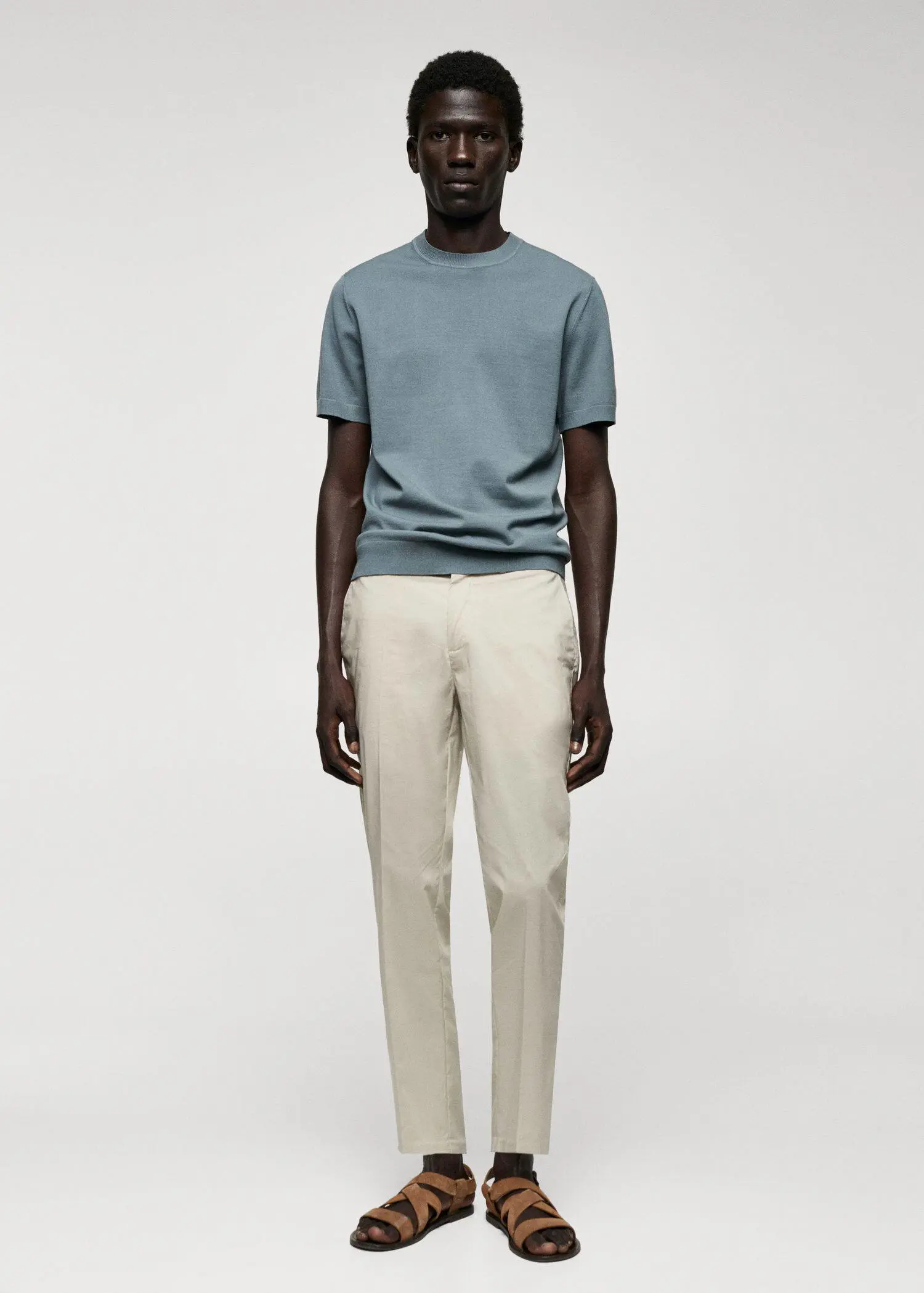 Mango Fine-knit T-shirt. a man standing in front of a white wall. 