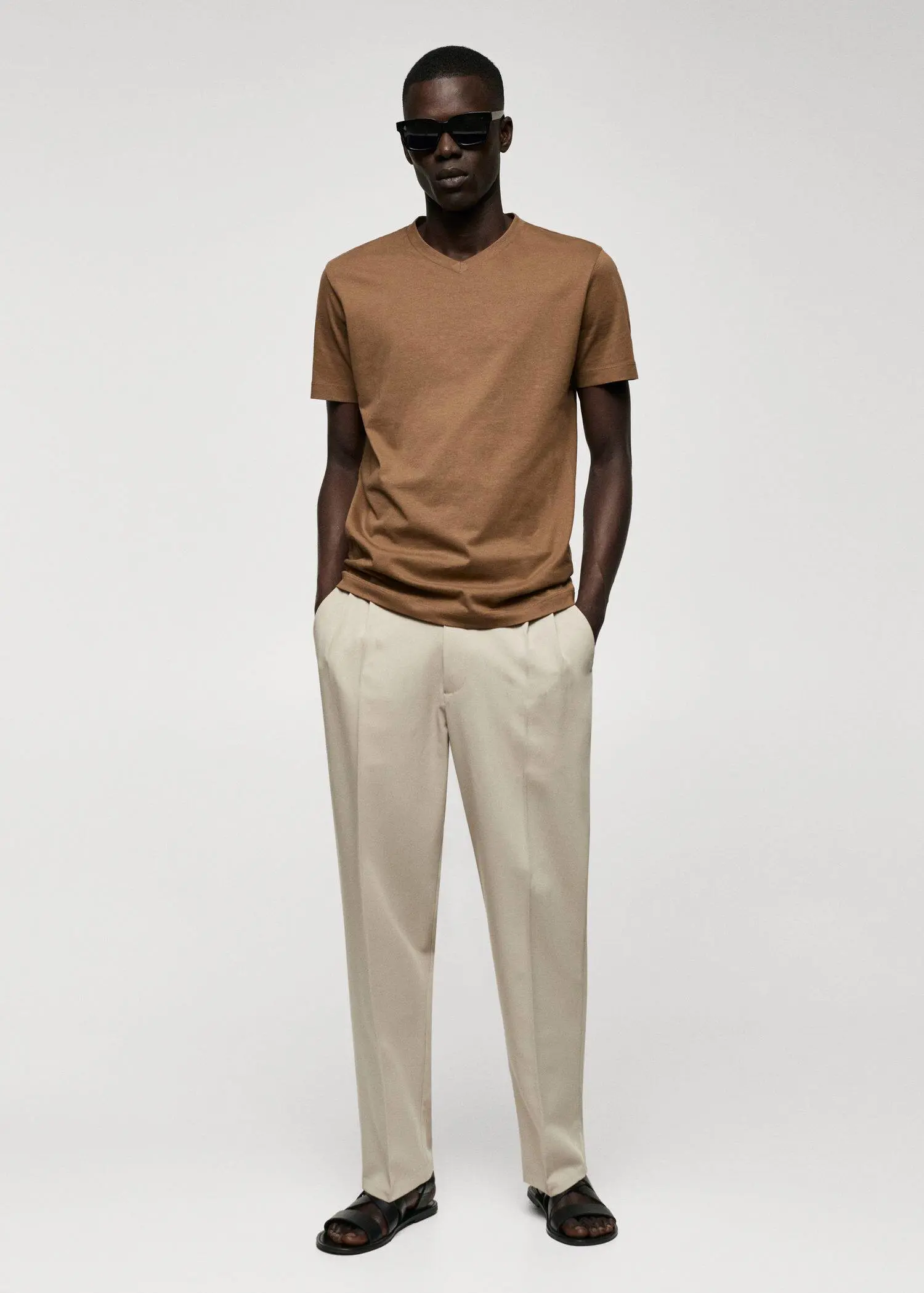 Mango Basic cotton V-neck T-shirt. a man standing with his hands in his pockets. 