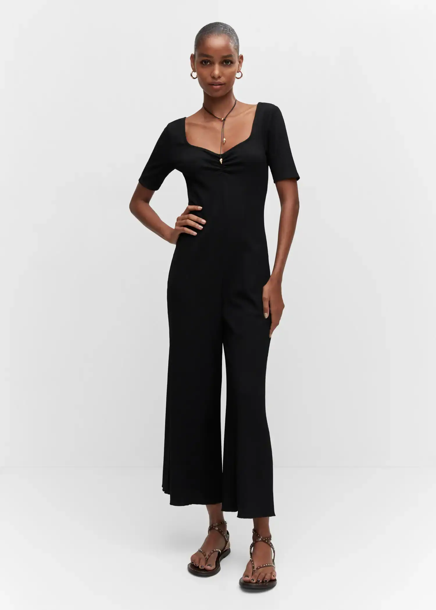Mango Ruched long jumpsuit. a woman in a black dress posing for a picture. 