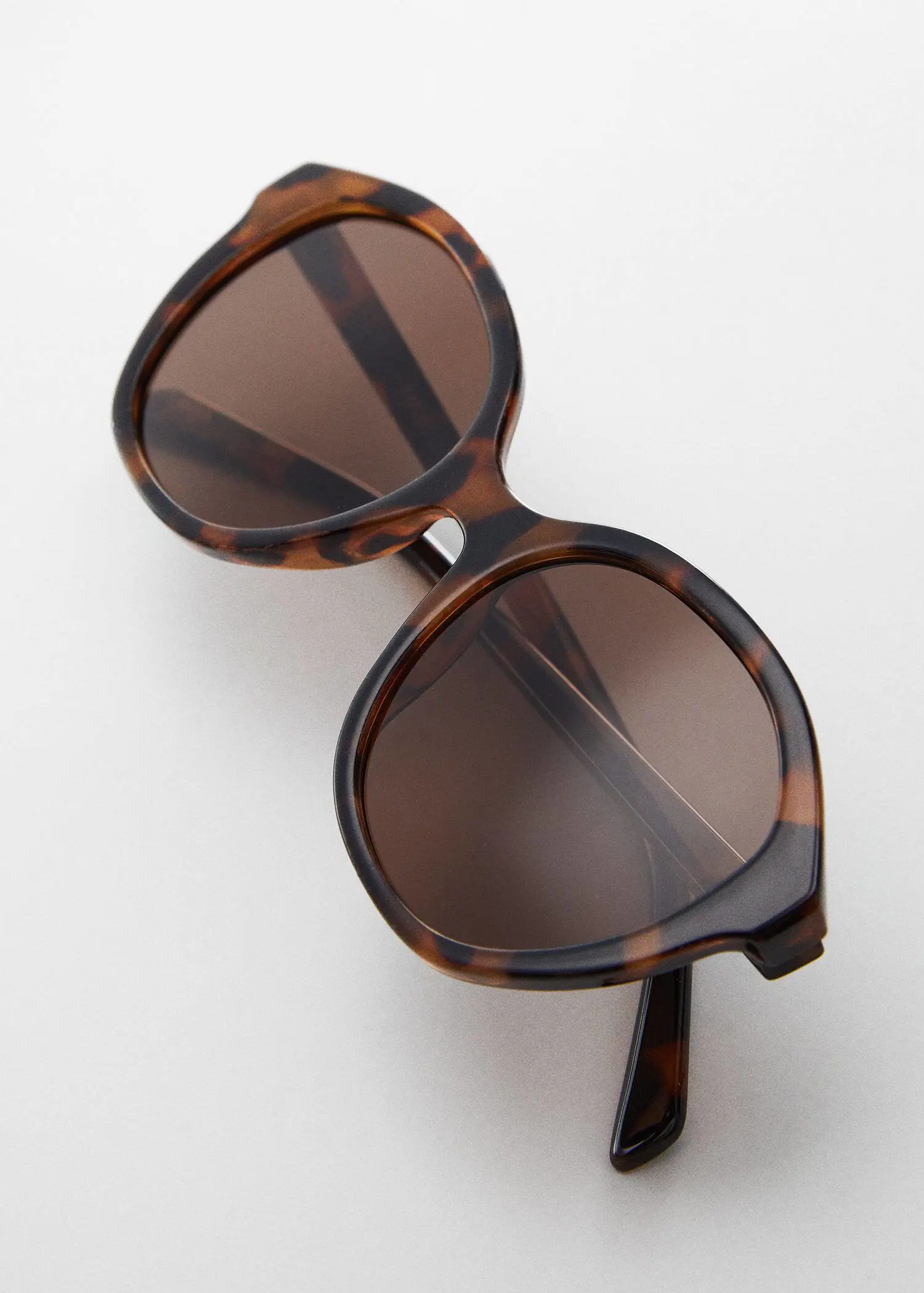 Mango Tortoiseshell rounded sunglasses. a close up of a pair of sun glasses 