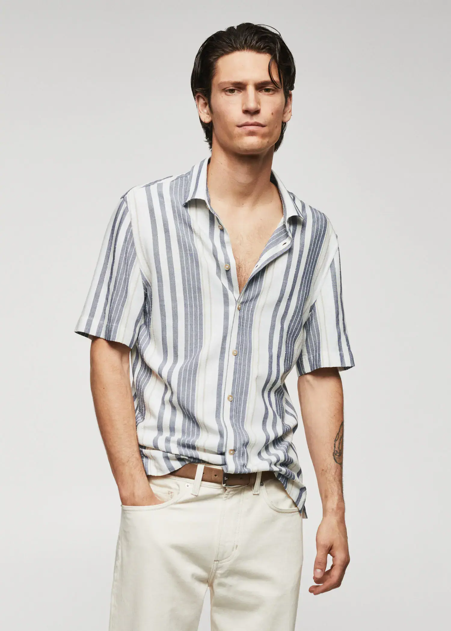 Mango Striped slim-fit shirt. a man in a striped shirt is posing. 