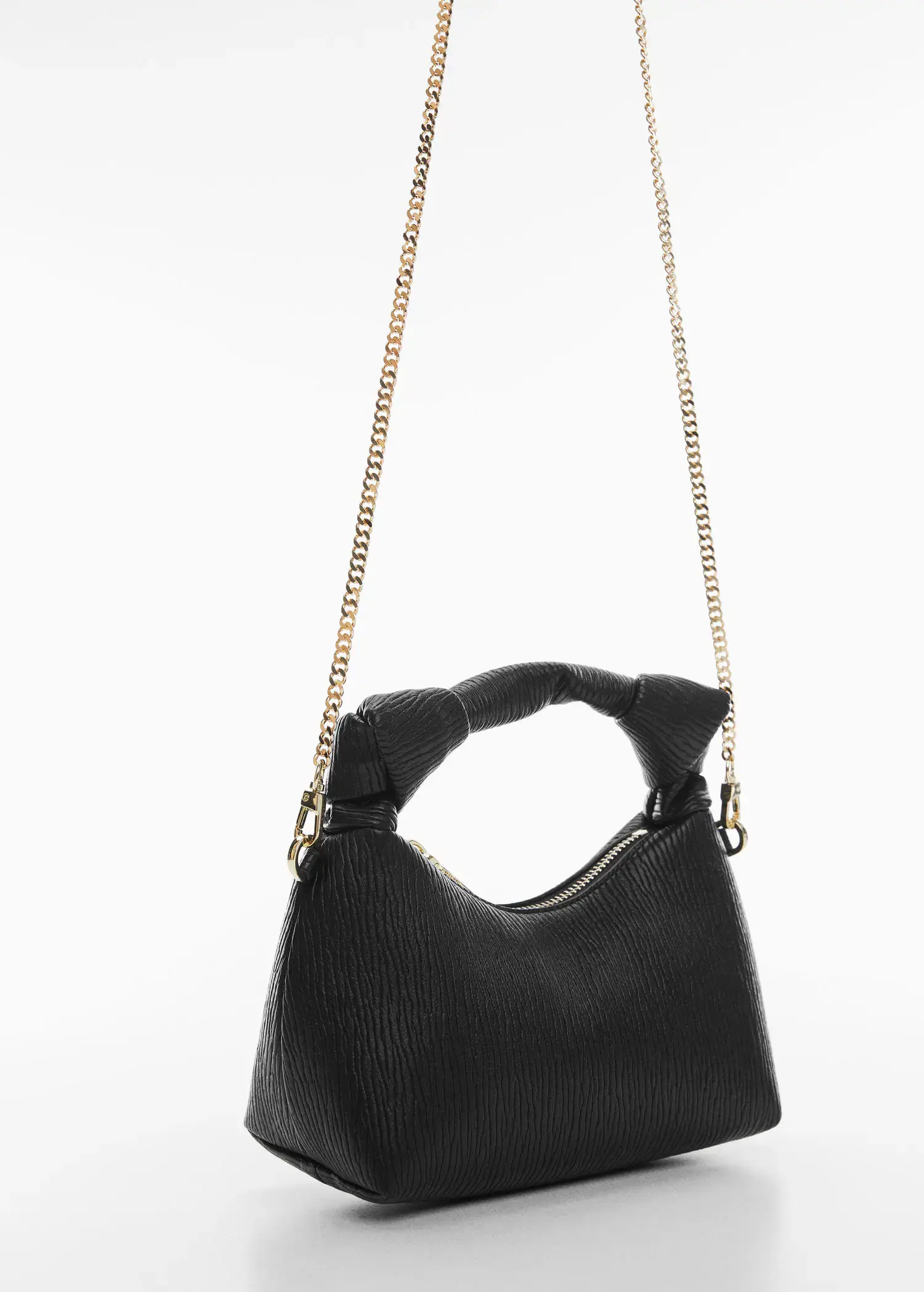 Mango Textured knot handle bag. a close up of a black purse on a white background 