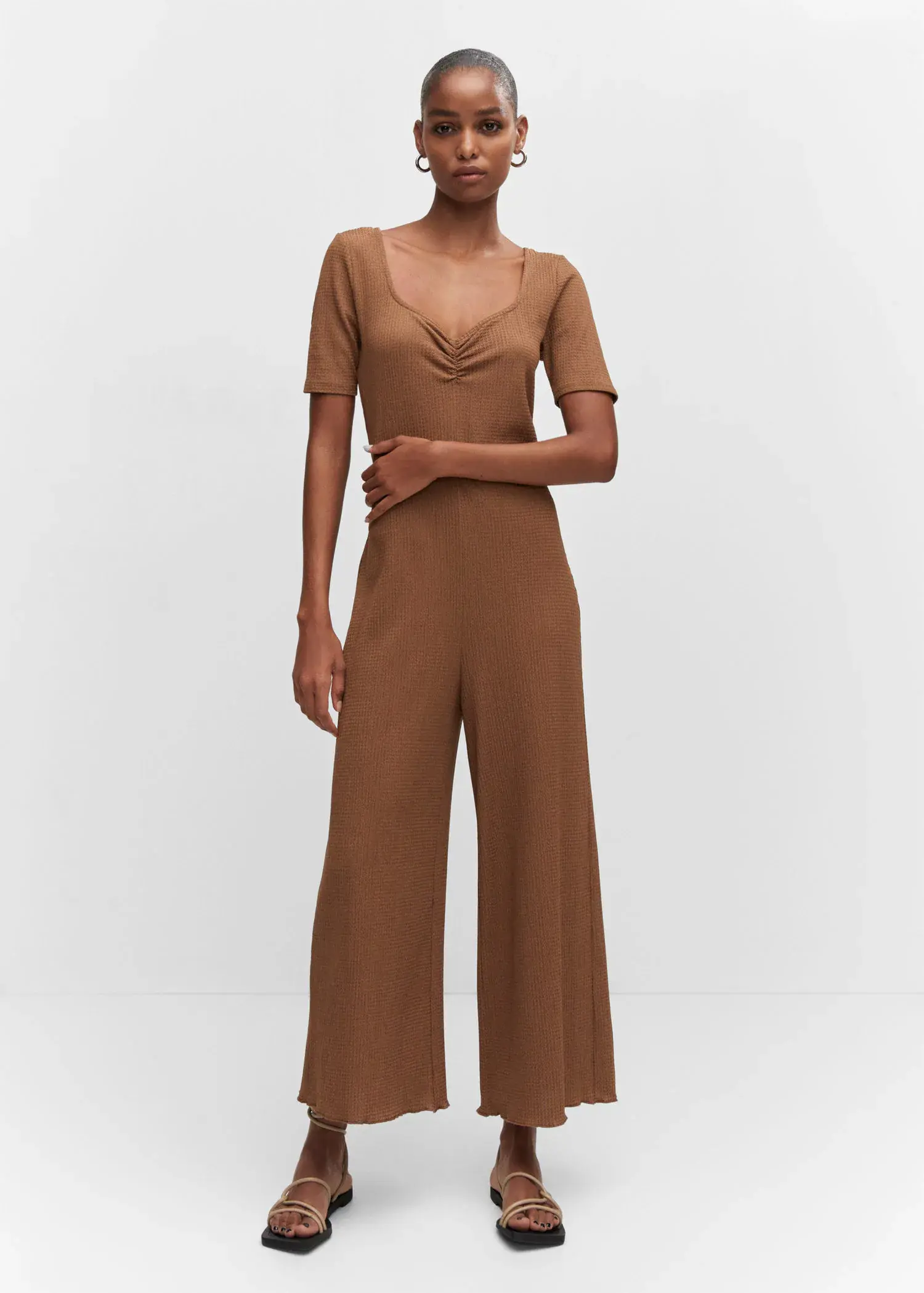 Mango Ruched long jumpsuit. a woman in a brown jumpsuit is posing for a picture. 