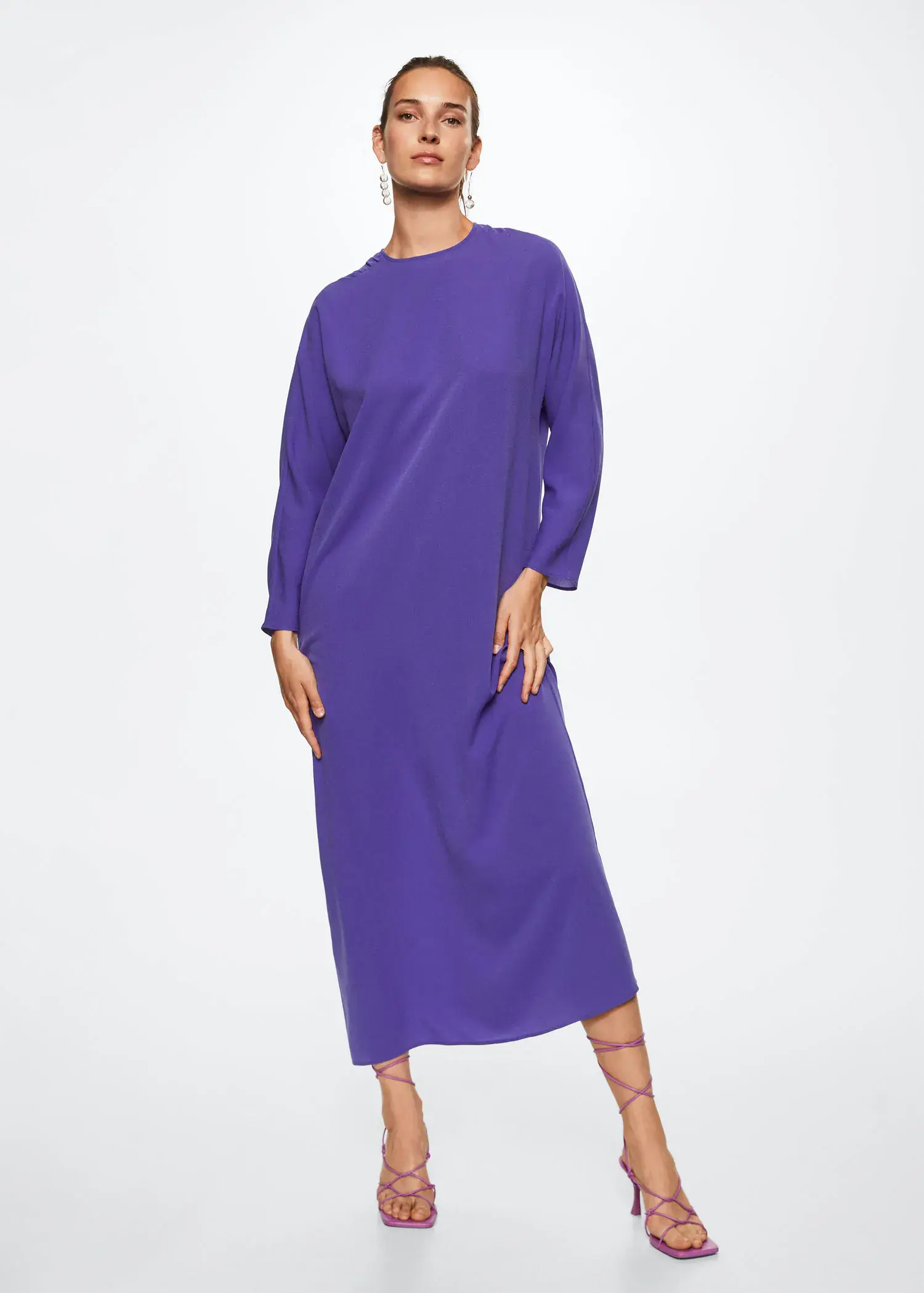 Mango Ruched detail dress. a woman wearing a purple dress standing in front of a white wall. 